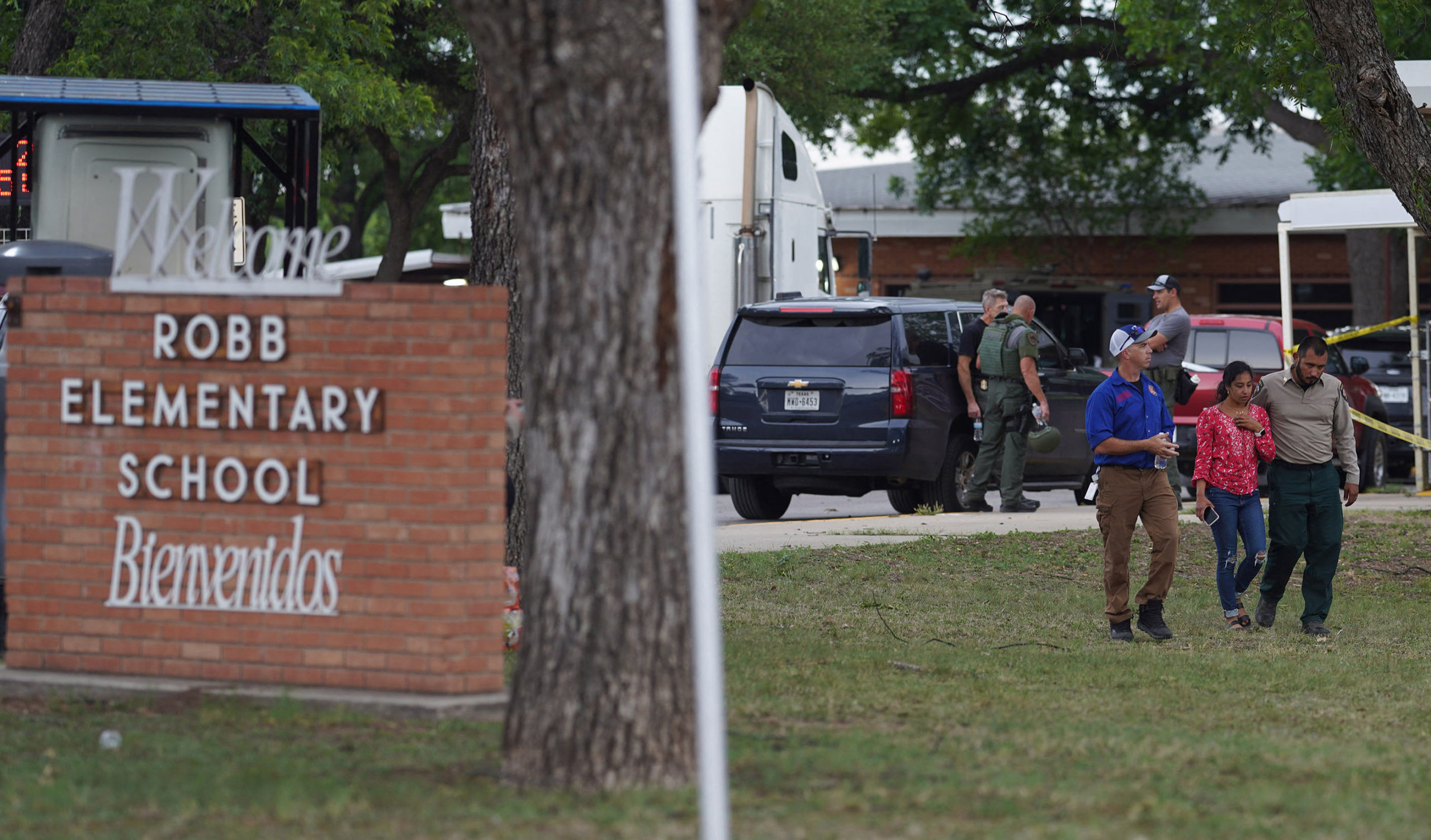 A welcome sign is seen outside of Robb Elementary School as people walk away in Uvalde, Texas, on May 24, 2022. - A teenage gunman killed 18 young children in a shooting at an elementary school in Texas on Tuesday, in the deadliest US school shooting in years. The attack in Uvalde, Texas -- a small community about an hour from the Mexican border -- is the latest in a spree of deadly shootings in America, where horror at the cycle of gun violence has failed to spur action to end it. (Photo by ALLISON DINNER/AFP via Getty Images)