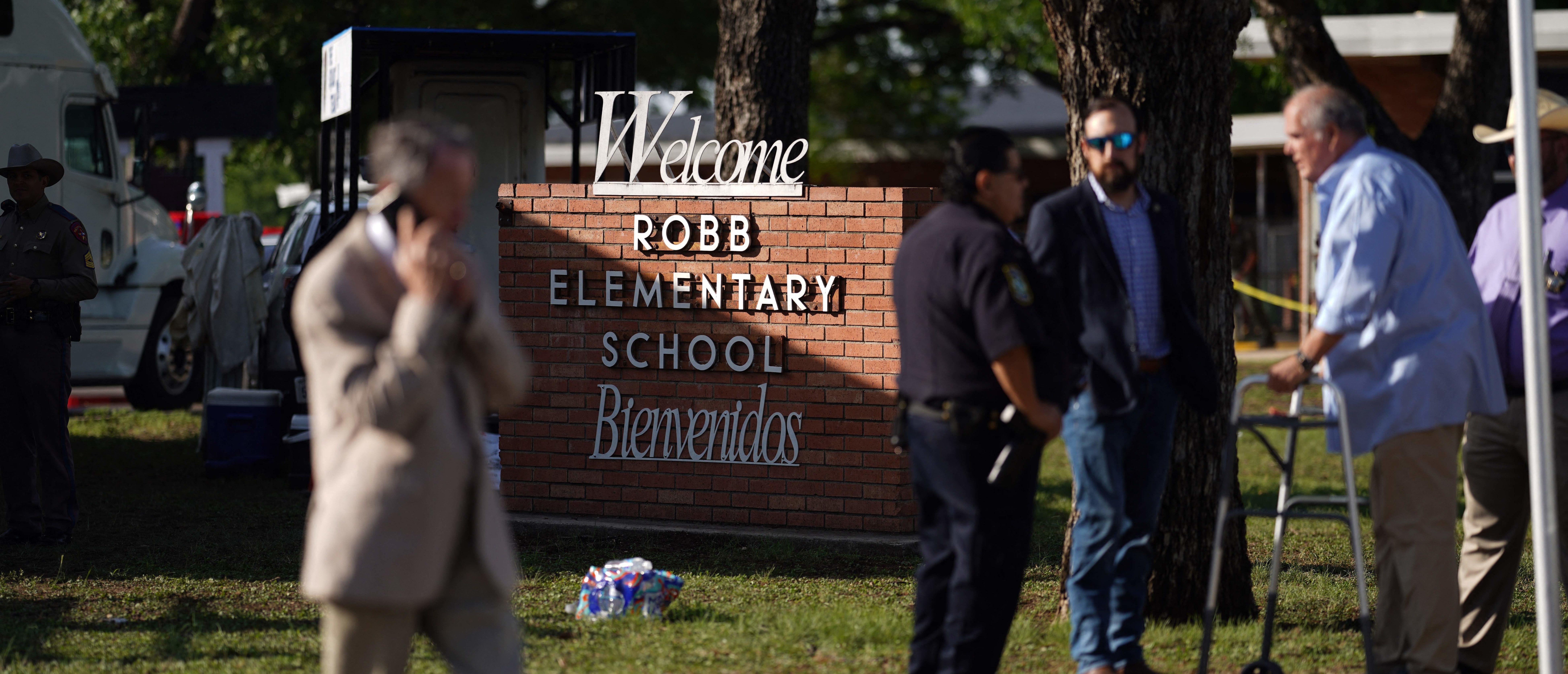 Uvalde, Texas, Mayor Don McLaughlin (R) speaks with an officer outside Robb Elementary School in Uvalde, Texas, on May 25, 2022. - A tight-knit Latino community in Texas was wracked with grief Wednesday after a teen in body armor marched into an elementary school and killed 19 small children and two teachers, in the latest spasm of deadly gun violence in America. (Photo by allison dinner / AFP) (Photo by ALLISON DINNER/AFP via Getty Images)