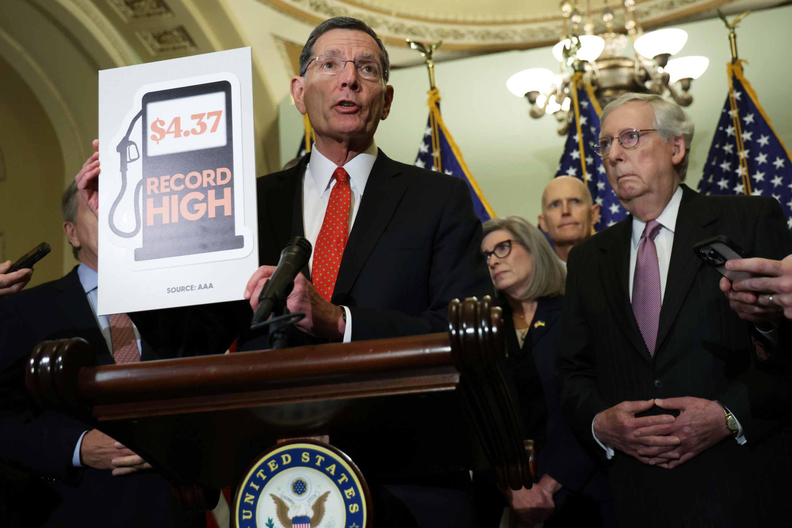 Republican Sen. John Barrasso holds up a sign about gasoline prices on May 10. (Alex Wong/Getty Images)