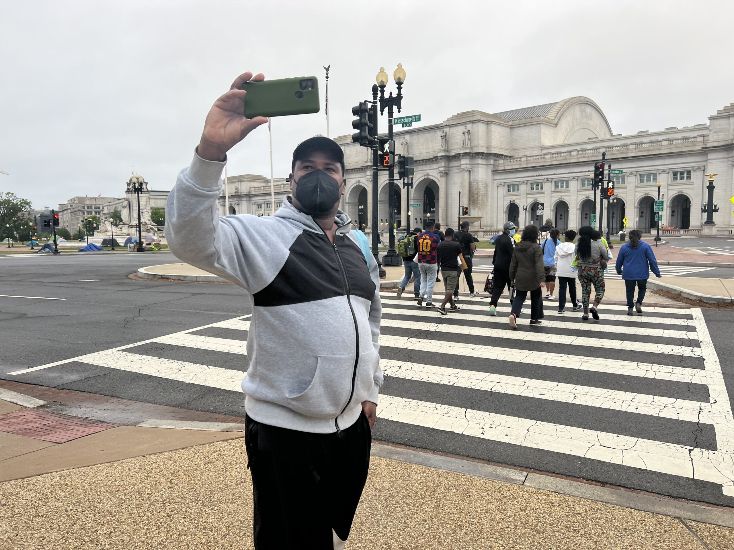A migrant bused from Texas take selfies in D.C. Jennie Taer//Daily Caller News Foundation