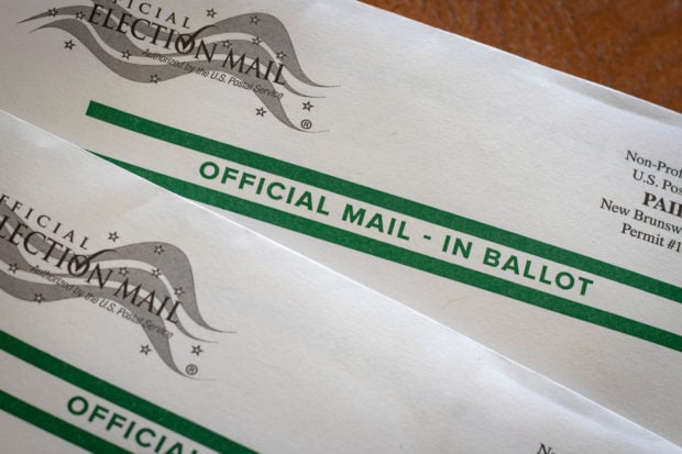 Picture of mail-in ballot [Shutterstock/Benjamin Clapp]
