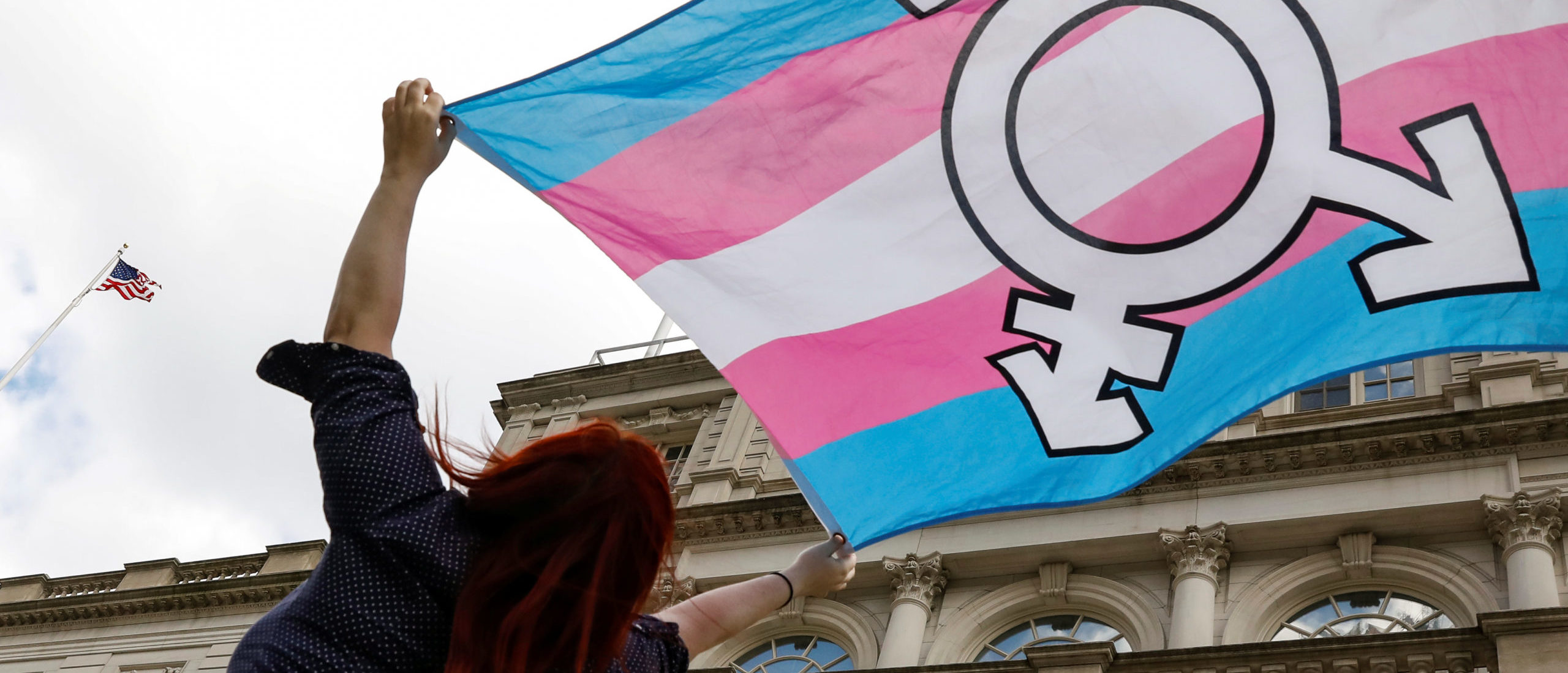 A person holds up a flag during rally to protest the Trump administration's reported transgender proposal to narrow the definition of gender to male or female at birth, at City Hall in New York City, U.S., October 24, 2018.