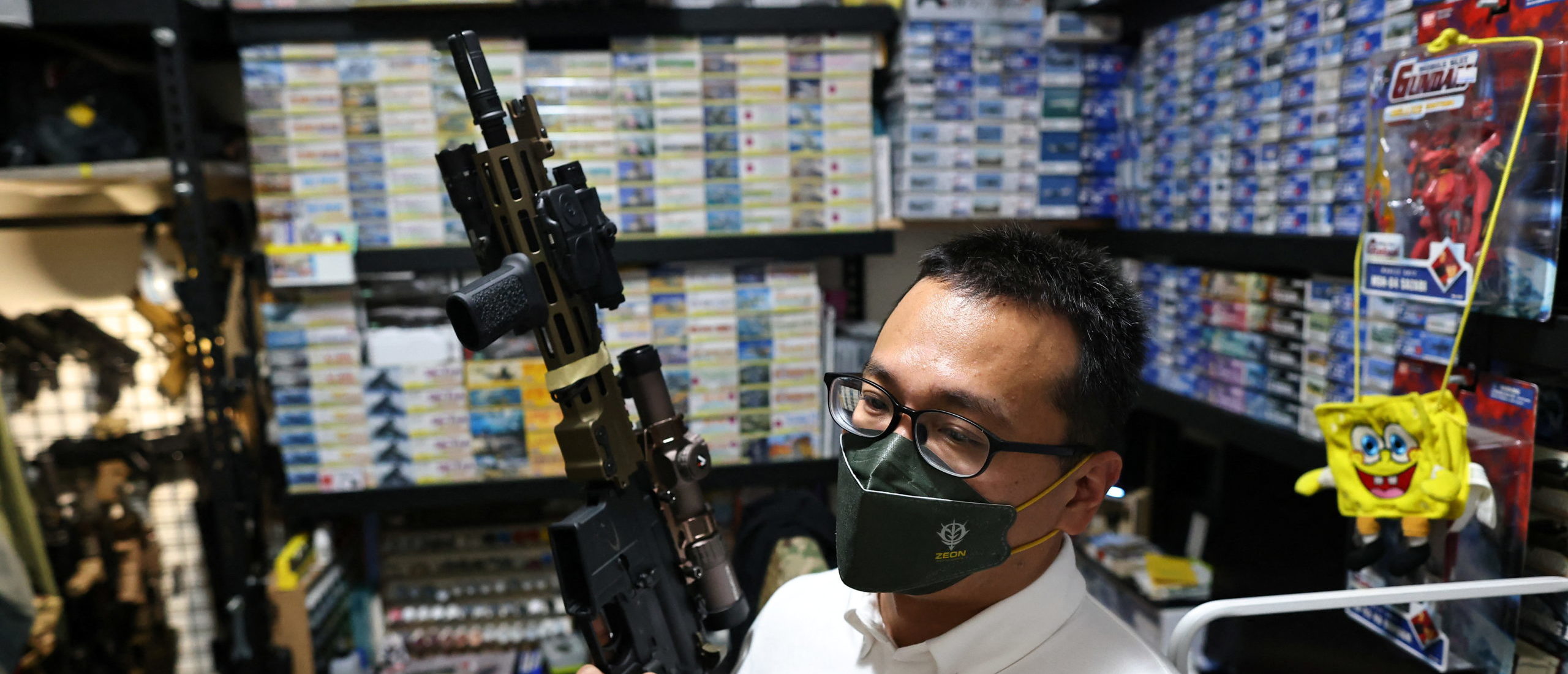 Lin Ping-yu, 38, a politician for the ruling Democratic Progressive Party who is competing for a seat in the local council, displays of one of his 12 airsoft guns at his home in New Taipei City, Taiwan, May 31,2022. Lin said the Ukraine war had prompted him to prepare survival kits for his family, complete with emergency food supplies and batteries, in case of the worst. (REUTERS/Ann Wang)