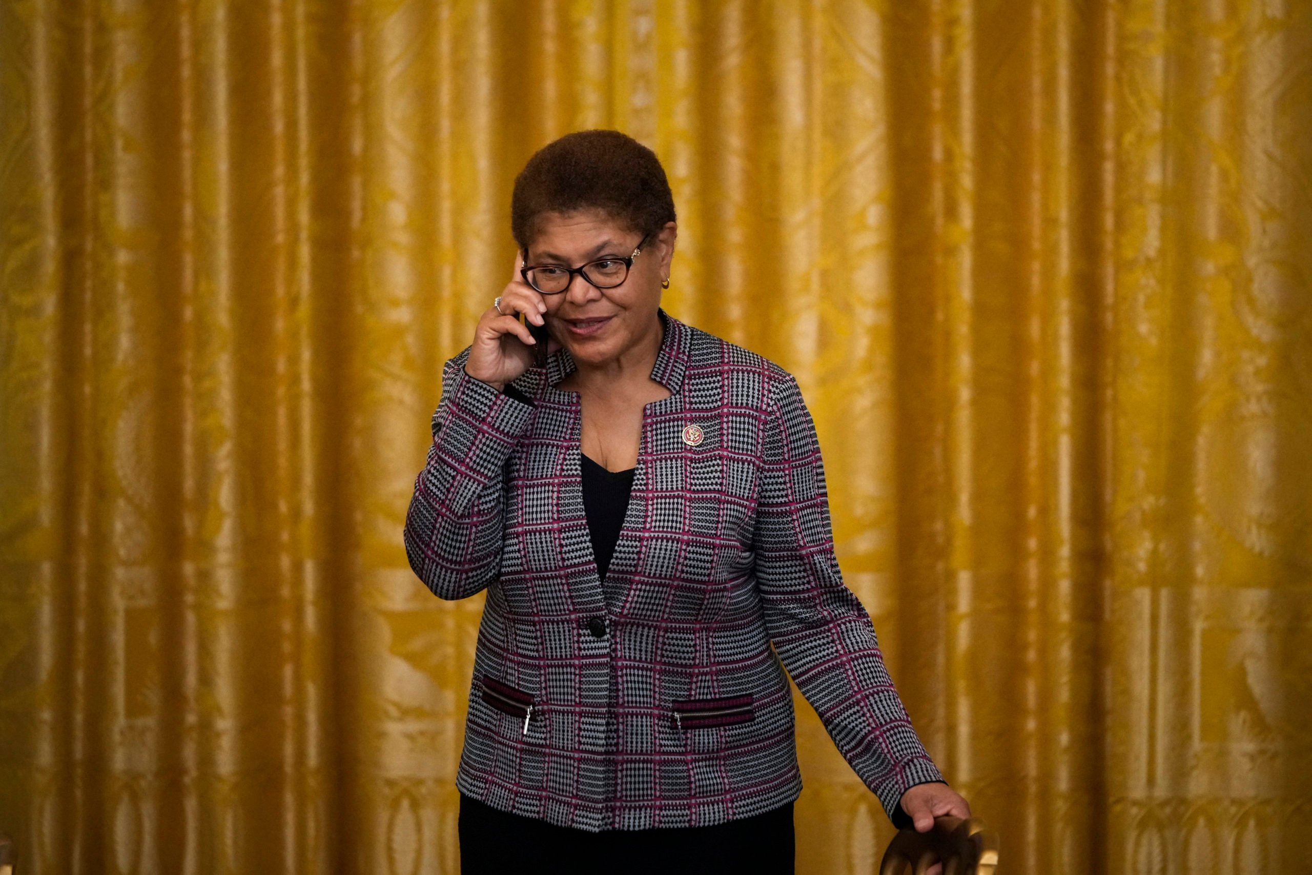 Rep. Karen Bass (D-CA) speaks on the phone before U.S. President Joe Biden signs the Juneteenth National Independence Day Act into law in the East Room of the White House on June 17, 2021 in Washington, DC. (Photo by Drew Angerer/Getty Images)