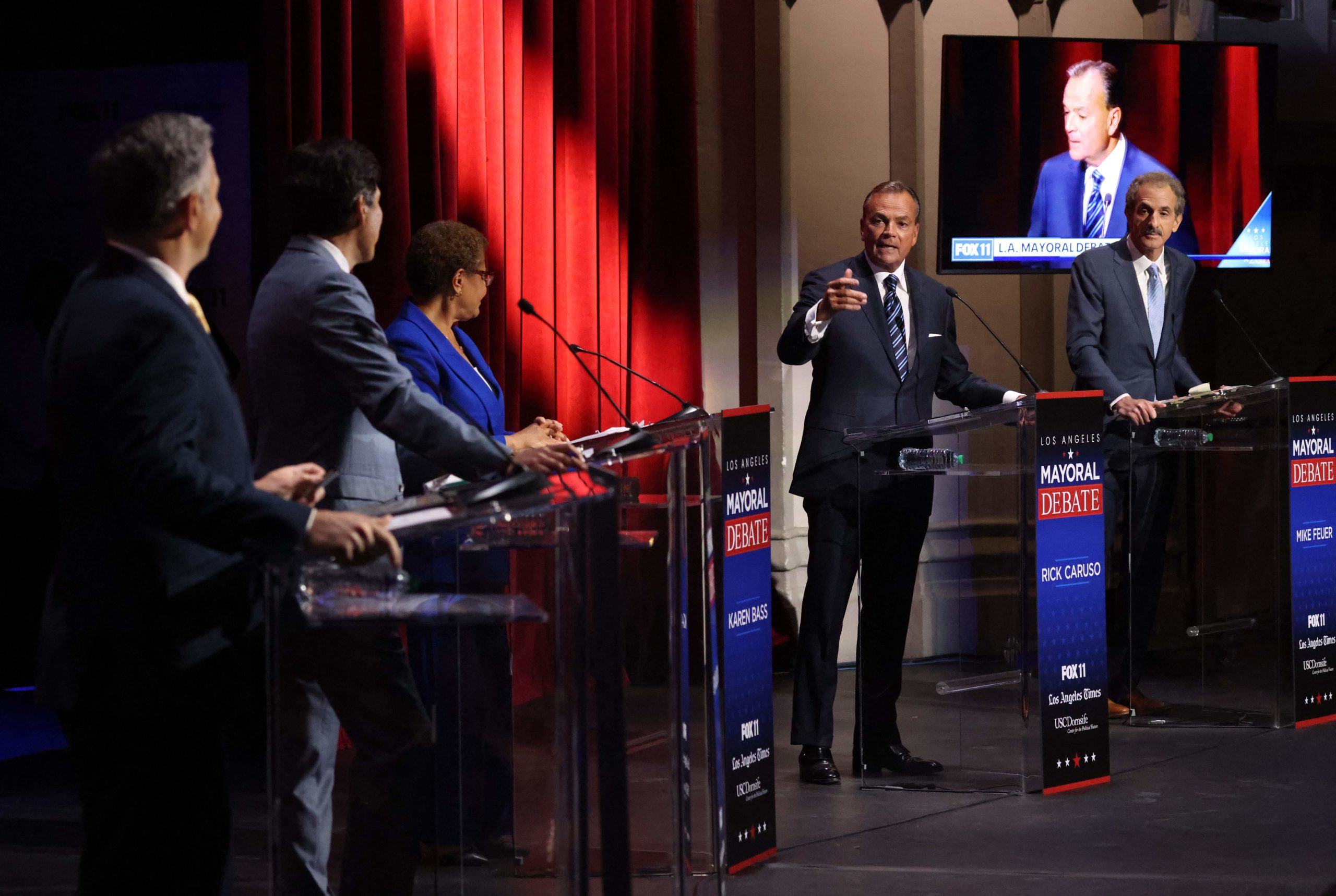 Rick Caruso (2nd R) makes a rebuttal during the mayoral debate with candidates (from L) Joe Buscaino, Kevin de Leon, Karen Bass and Mike Feuer at USC's Bovard Auditorium, March 22, 2022 in Los Angeles. (Photo by MYUNG J. CHUN/POOL/AFP via Getty Images)