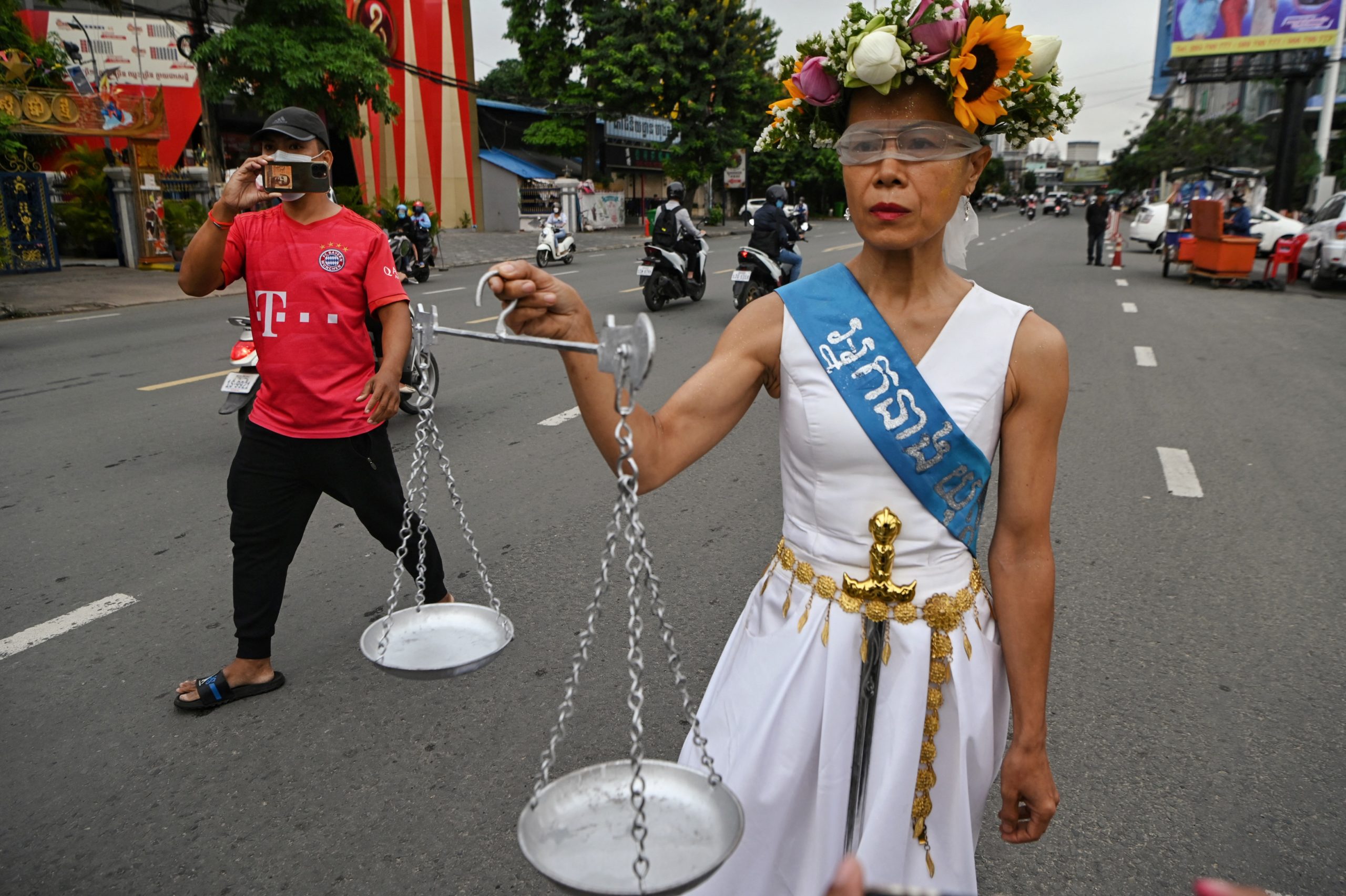Theary Seng (R), a US-Cambodian lawyer and activist who is facing treason and incitement charges, walks in the street in front of Phnom Penh municipal court ahead of her hearing in Phnom Penh on May 3, 2022. (Photo by TANG CHHIN Sothy / AFP via Getty Images)