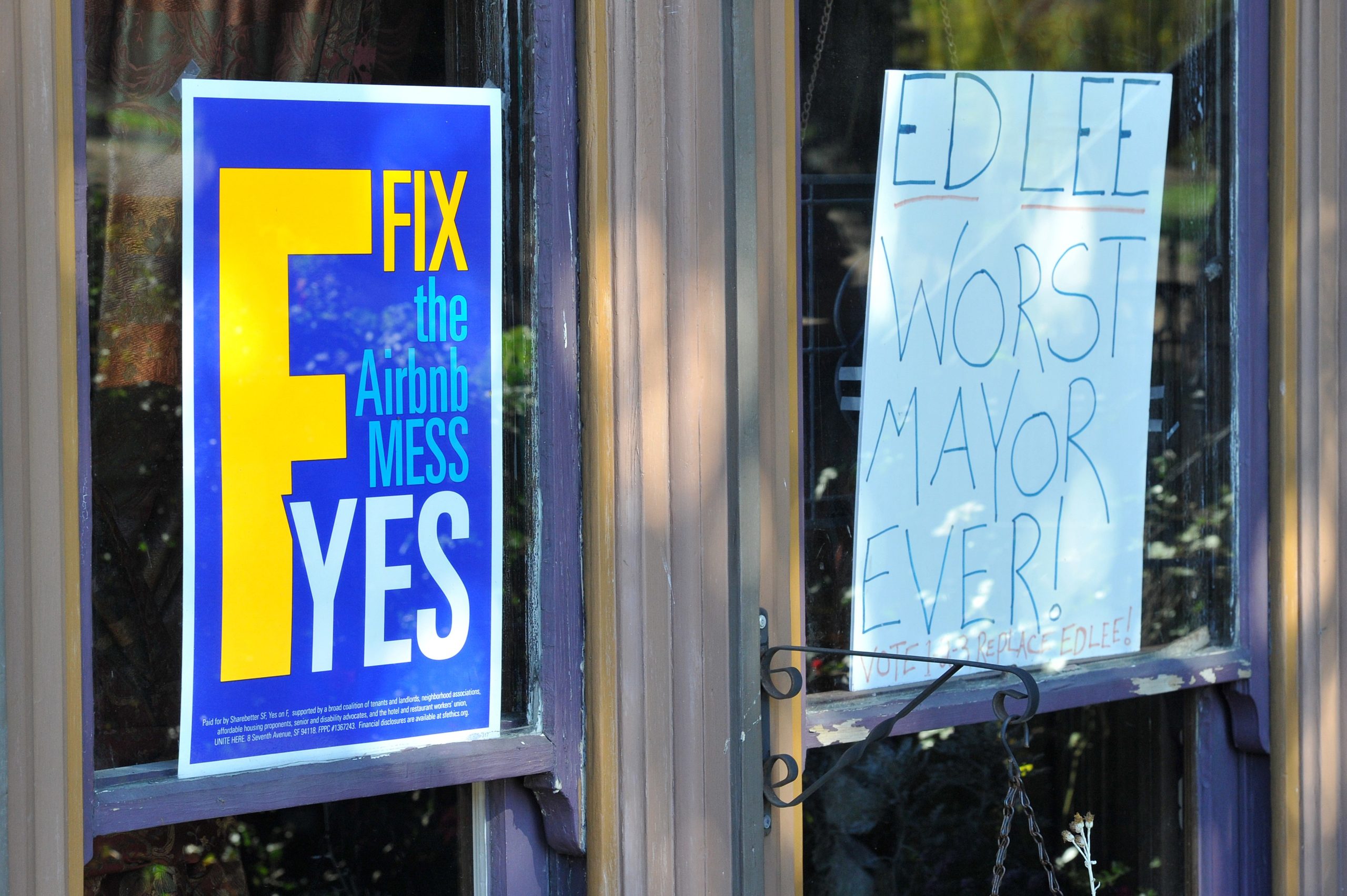 Signs showing support for Proposition F and opposition to San Francisco's current mayor Ed Lee are seen in the window of a home in San Francisco, California on November 3, 2015. Proposition Fknown to some as the Airbnb initiativerestricts short term rentals in the city which some say have contributed to skyrocketing rental rates. (Josh Edelson/AFP via Getty Images)