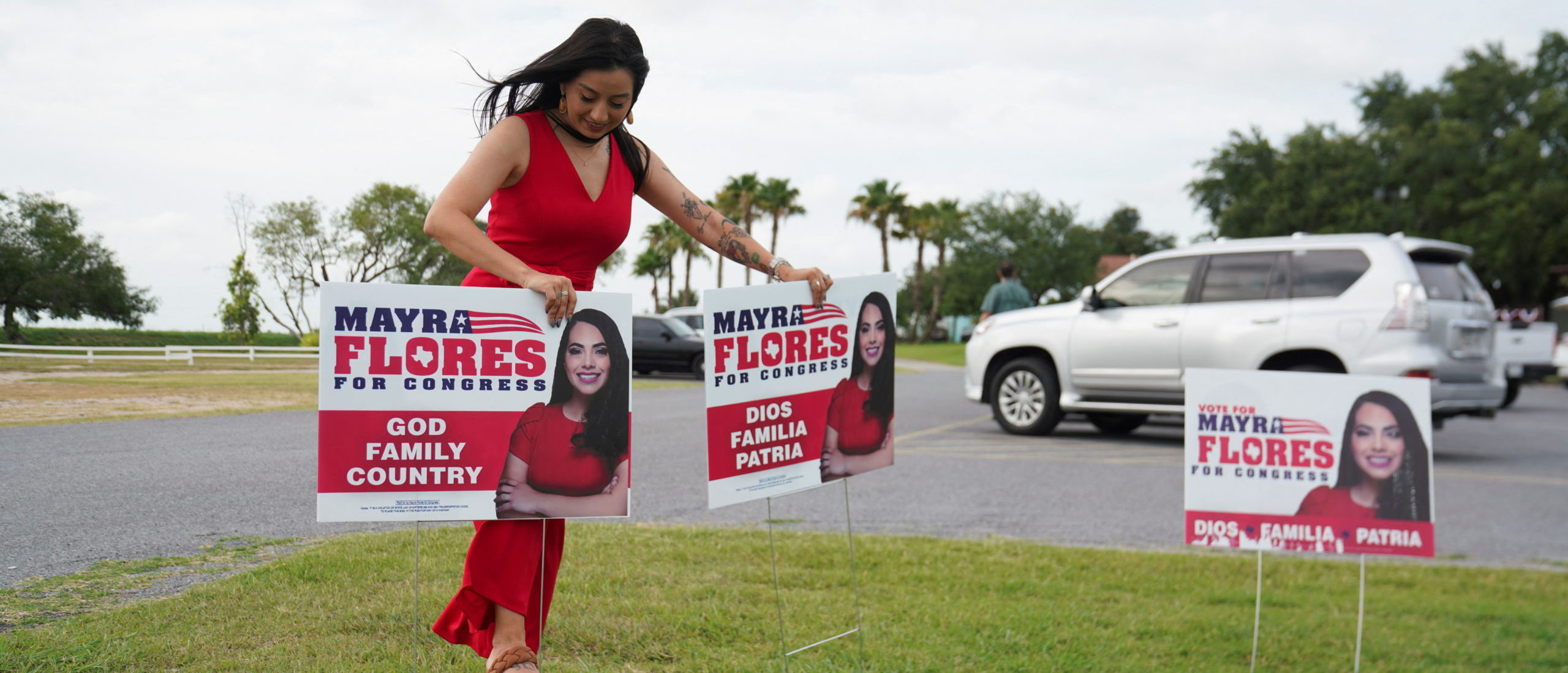 Sabrina Cantu, volunteer coordinator for Mayra Flores, a Republican candidate who is running for the vacant 34th congressional district seat, puts up signs outside their watch party event in San Benito, Texas, U.S., June 14, 2022. REUTERS/Veronica G. Cardenas