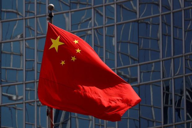 FILE PHOTO: The Chinese national flag is seen in Beijing, China April 29, 2020. REUTERS/Thomas Peter/File Photo