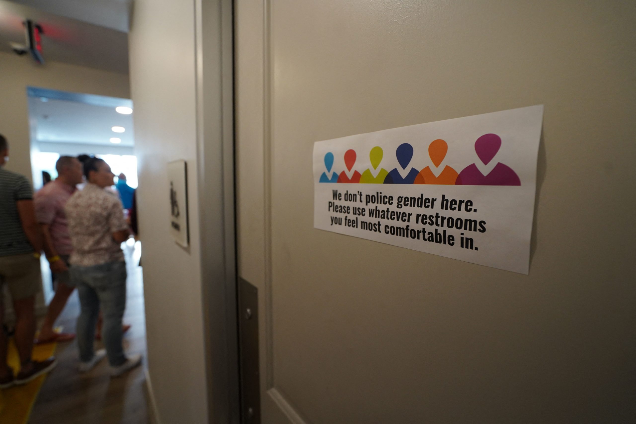 A bathroom sign is seen during the opening the Law Harrington Senior Living Center, the largest LGBTQ senior residence in the US in Houston, Texas on June 24, 2021. - Life has thrown a lot of roadblocks at Dina Jacobs, a transgender woman, for trying to live authentically. But now, she can finally see the light at the end of the tunnel. "Look, everything comes through eventually. Five million no's and one yes, and this is it. This is my yes!" says Jacobs, who spent her 57-year career on stage as a drag performer. Jacobs, a Hawaiian native, is showing a reporter the modest one-bedroom apartment she is now able to rent for less than $500 a month in the first residence in the southern United States exclusively for LGBTQ (lesbian, gay, bisexual, transgender and queer) people. (Photo by Francois PICARD / AFP) (Photo by FRANCOIS PICARD/AFP via Getty Images)