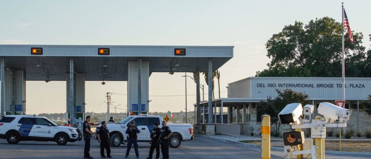 US Customs and Border Protection agents guard the entrance to the Del Rio International Bridge, which is closed temporarily after an influx of migrants, at the US-Mexico border in Del Rio, Texas on September 17, 2021. - The mayor of Del Rio, Texas declared a state of emergency on September 17 after more than 10,000 undocumented migrants, many of them Haitians, poured into the border city in a fresh test of President Joe Biden's immigration policy. Del Rio Mayor Bruno Lozano said that the migrants were crowded in an area controlled by the US Customs and Border Patrol (CBP) beneath the Del Rio International Bridge, which carries traffic across the Rio Grande river into Mexico. (Photo by PAUL RATJE / AFP) (Photo by PAUL RATJE/AFP via Getty Images)