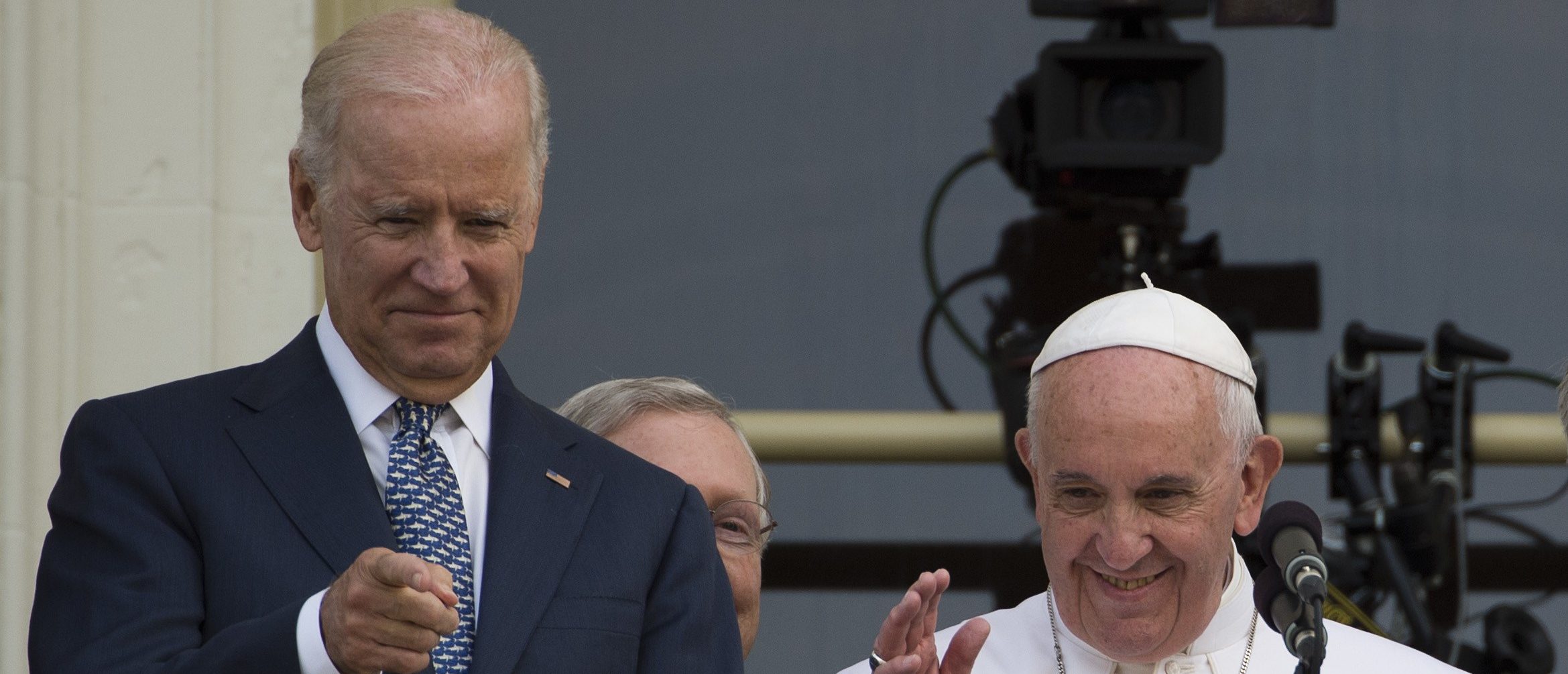 Pope Francis waves, next to US Vice President Joe Biden, on a balcony after speaking at the US Capitol building in Washington, DC on September 24, 2015. AFP PHOTO/ ANDREW CABALLERO-REYNOLDS (Photo credit should read Andrew Caballero-Reynolds/AFP via Getty Images)