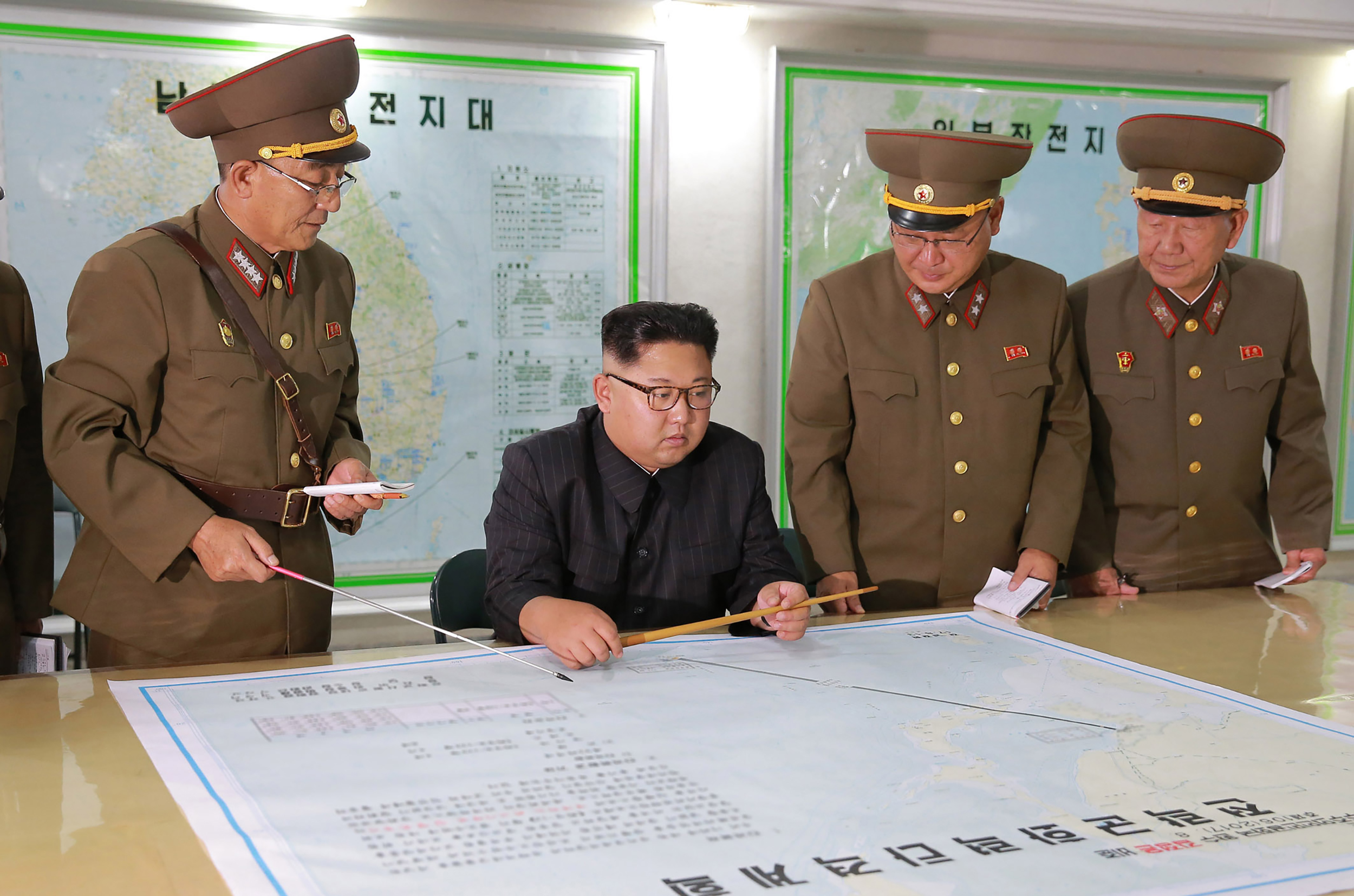 TOPSHOT - This picture taken on August 14, 2017 and released from North Korea's official Korean Central News Agency (KCNA) on August 15, 2017 shows North Korean leader Kim Jong-Un (C) inspecting the Command of the Strategic Force of the Korean People's Army (KPA) at an undisclosed location. North Korean leader Kim Jong-Un said on August 15 he would hold off on a planned missile strike near Guam, but warned the highly provocative move would go ahead in the event of further "reckless actions" by Washington. (STR/AFP via Getty Images)