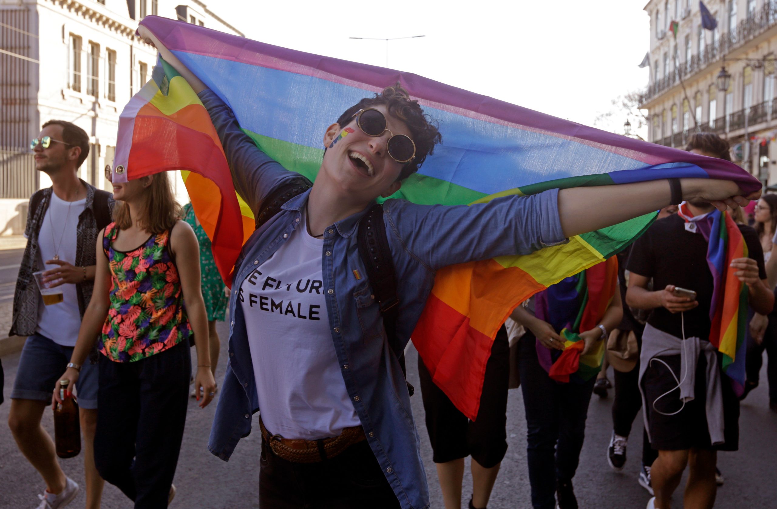 A woman holds a rainbow flag during the Lesbian, Gay, Bisexual, Transsexual, Transgender, Intersex Pride parade (LGBTI) in Lisbon on June 16, 2018. (Photo by JOSE MANUEL RIBEIRO / AFP) (Photo credit should read JOSE MANUEL RIBEIRO/AFP via Getty Images)