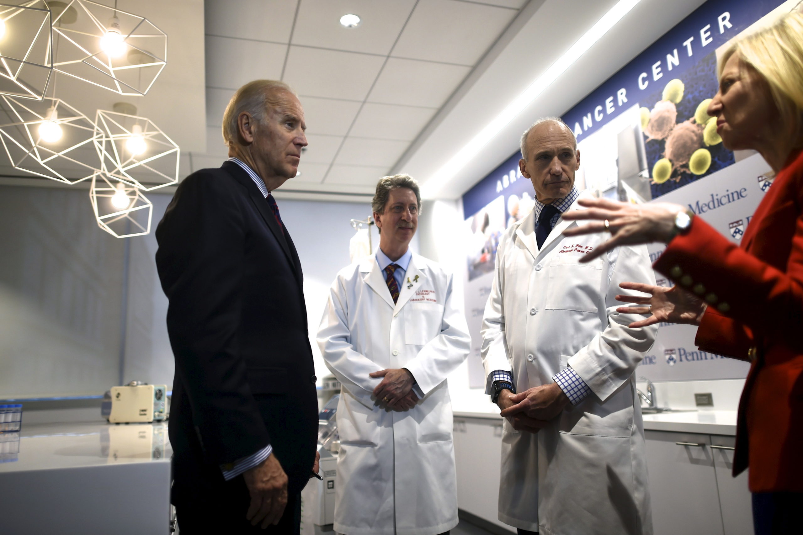 Vice President Joe Biden (L) meets with (C-R) Dr. Bruce Levine, Dr. Carl June, and University of Pennsylvania President Amy Gutmann while touring the University of Pennsylvania, Perelman School of Medicine and Abramson Cancer Center in Philadelphia, Pennsylvania January 15, 2016. During the State of the Union address Tuesday, President Obama tasked Biden to spearhead an initiative to cure cancer. REUTERS/Mark Makela
