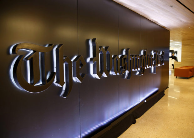 FILE PHOTO: FILE PHOTO: The newspaper's banner logo is seen during the grand opening of the Washington Post newsroom in Washington January 28, 2016. REUTERS/Gary Cameron/File Photo