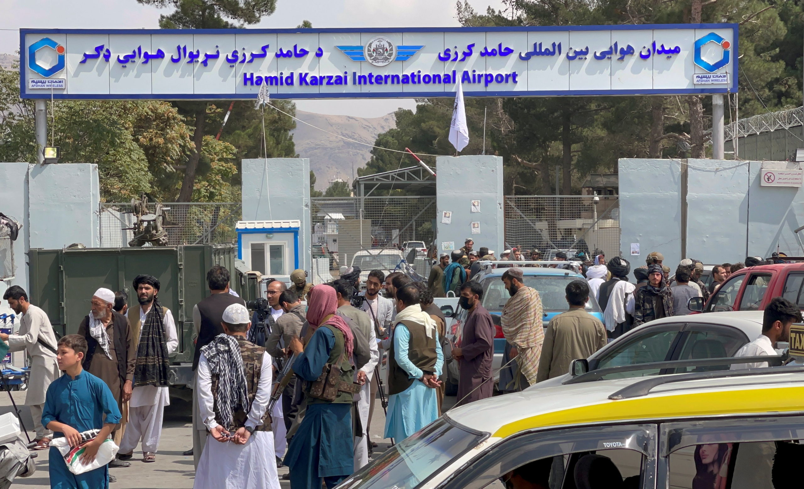 People gather at the entrance gate of Hamid Karzai International Airport a day after U.S troops withdrawal, in Kabul, Afghanistan August 31, 2021. REUTERS/Stringer