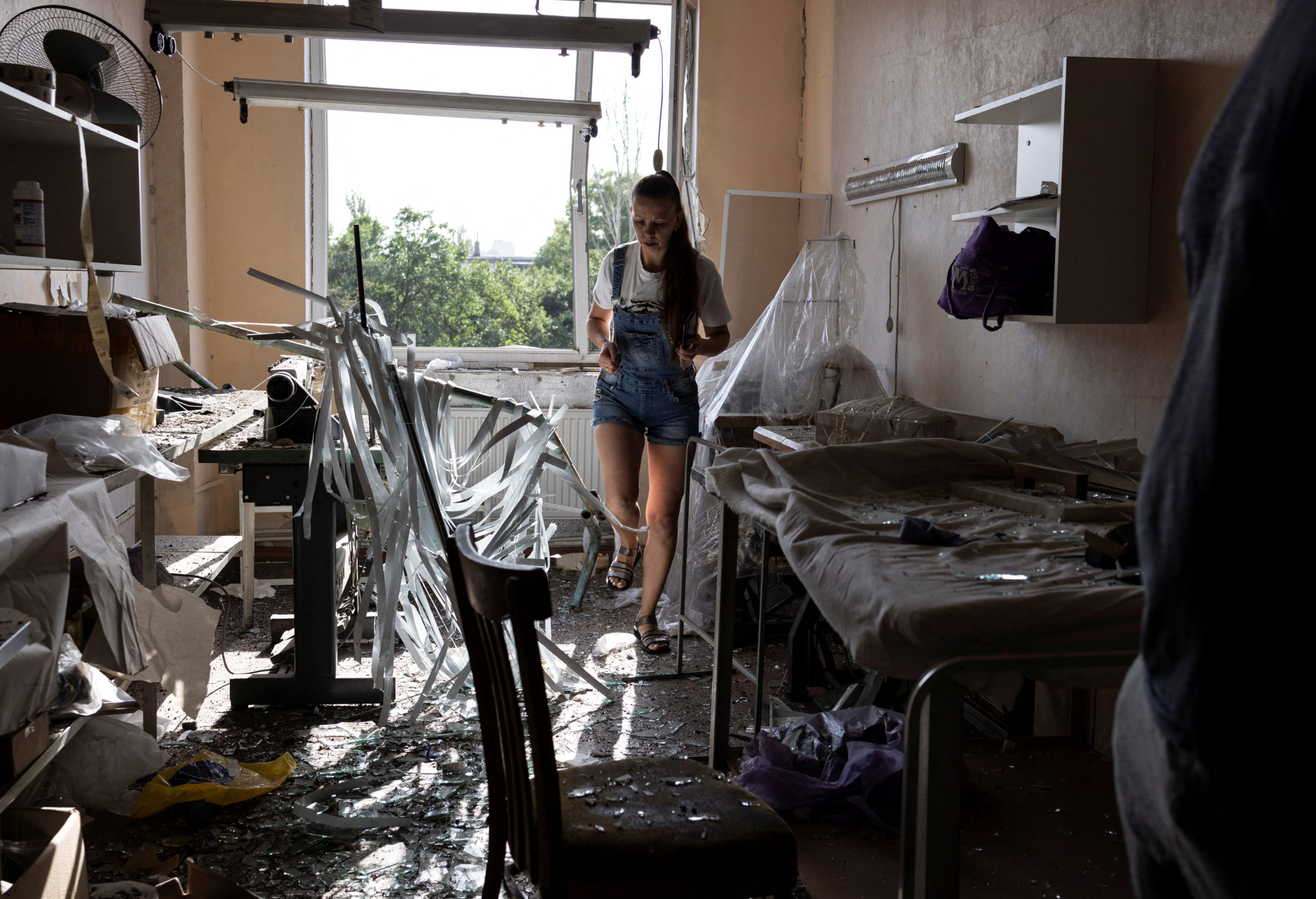 A local business owner inspects her sewing workshop damaged by a Russian missile strike, amid Russia's attack on Ukraine, in Mykolaiv, Ukraine August 22, 2022. 