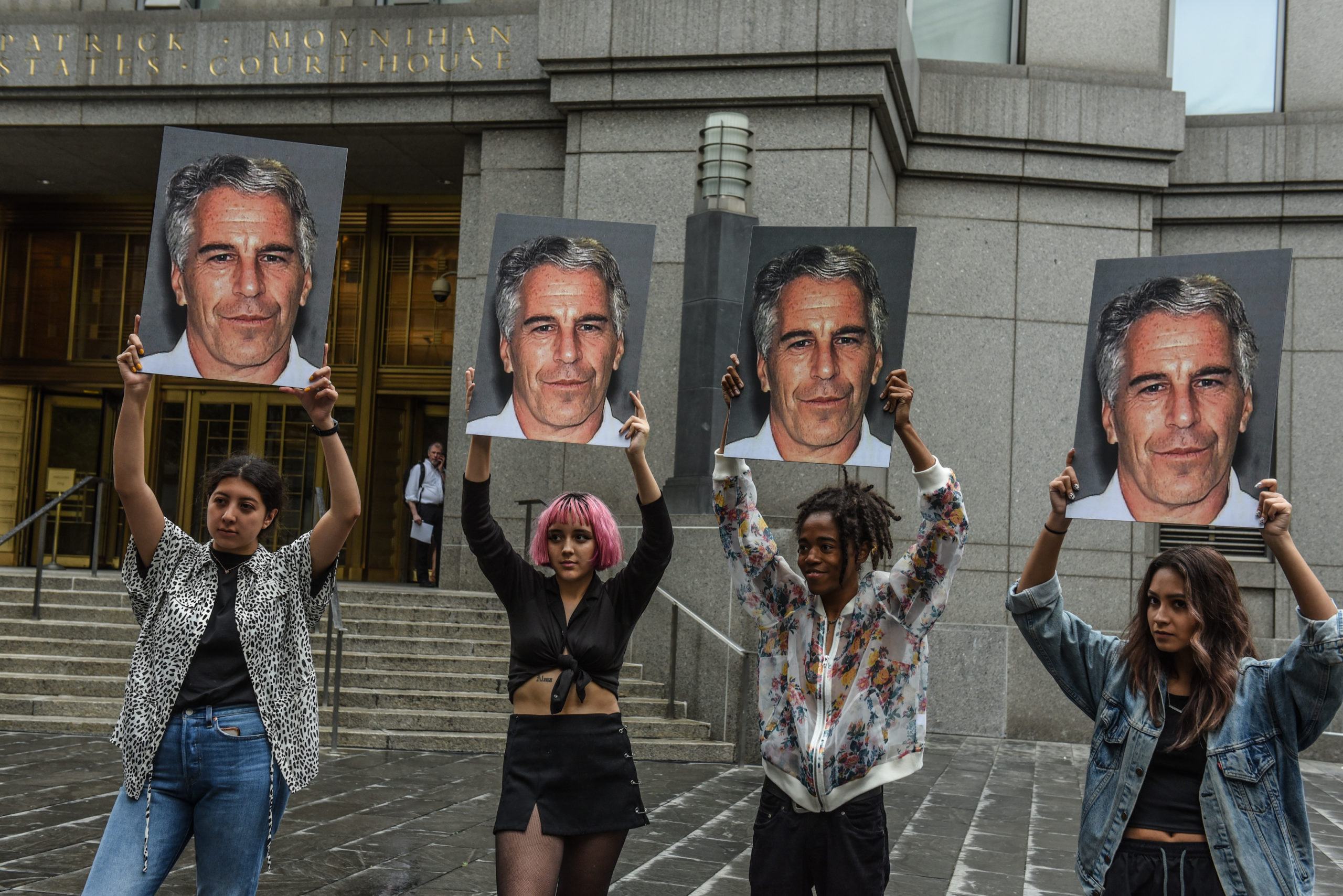 NEW YORK, NY - JULY 08: A protest group called "Hot Mess" hold up signs of Jeffrey Epstein in front of the Federal courthouse on July 8, 2019 in New York City. According to reports, Epstein will be charged with one count of sex trafficking of minors and one count of conspiracy to engage in sex trafficking of minors. (Photo by Stephanie Keith/Getty Images)