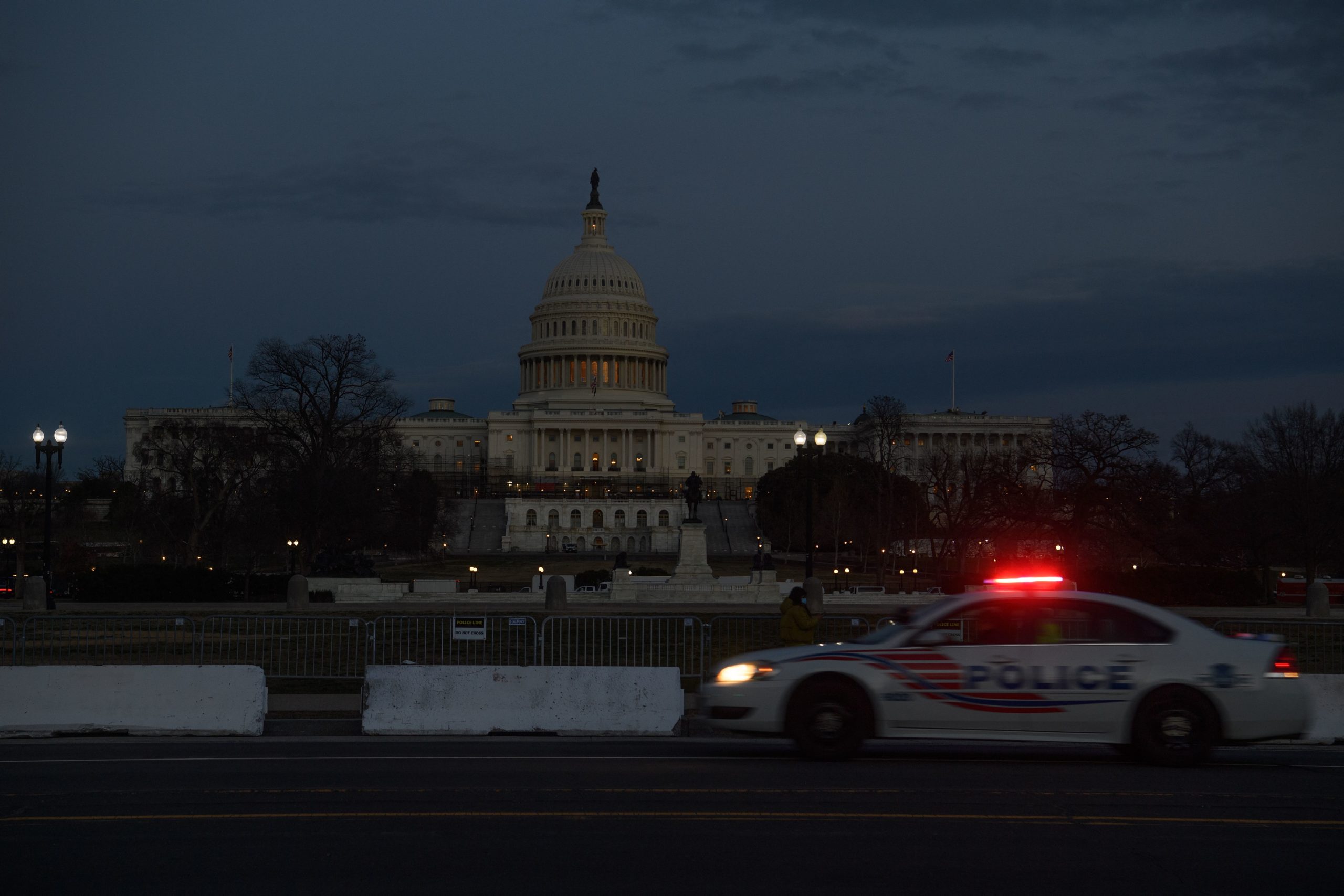 A police car drives past the US Capitol in Washington, DC, on March 1, 2022. - Embroiled in the most severe US-Russia crisis since the Cold War, President Joe Biden will take on a no less difficult domestic challenge during his State of the Union address: restoring Americans' optimism. NICHOLAS KAMM/AFP via Getty Images
