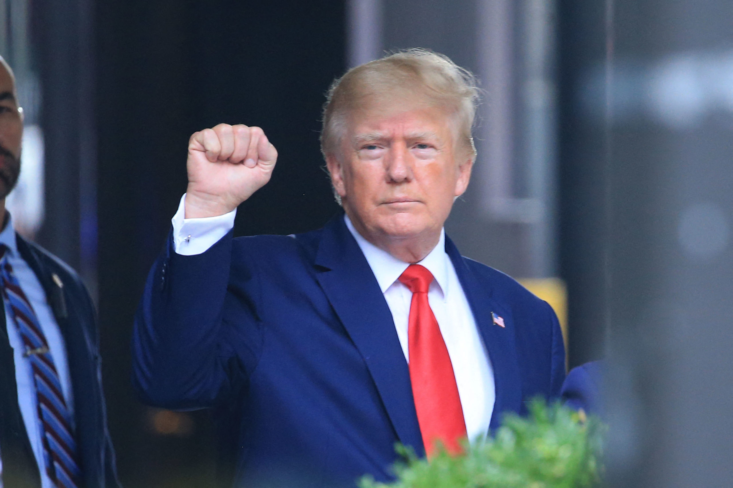 Former US President Donald Trump raises his fist while walking to a vehicle outside of Trump Tower in New York City on August 10, 2022. - Donald Trump on Wednesday declined to answer questions under oath in New York over alleged fraud at his family business, as legal pressures pile up for the former president whose house was raided by the FBI just two days ago. (Photo by STRINGER/AFP via Getty Images)