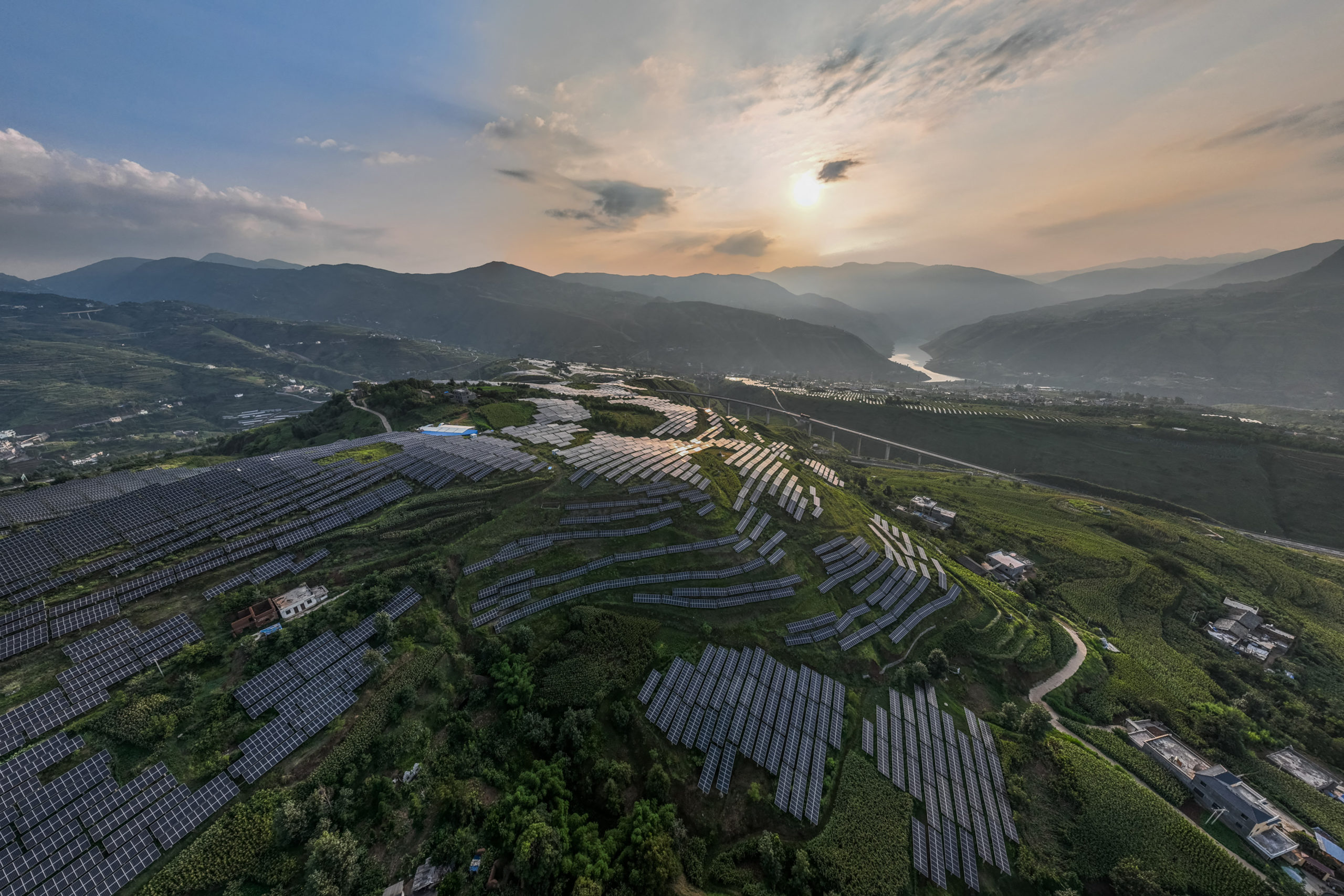 TOPSHOT - This photo taken on August 16, 2022 shows solar panels among Sichuan pepper field in Bijie, in China's southwestern Guizhou province