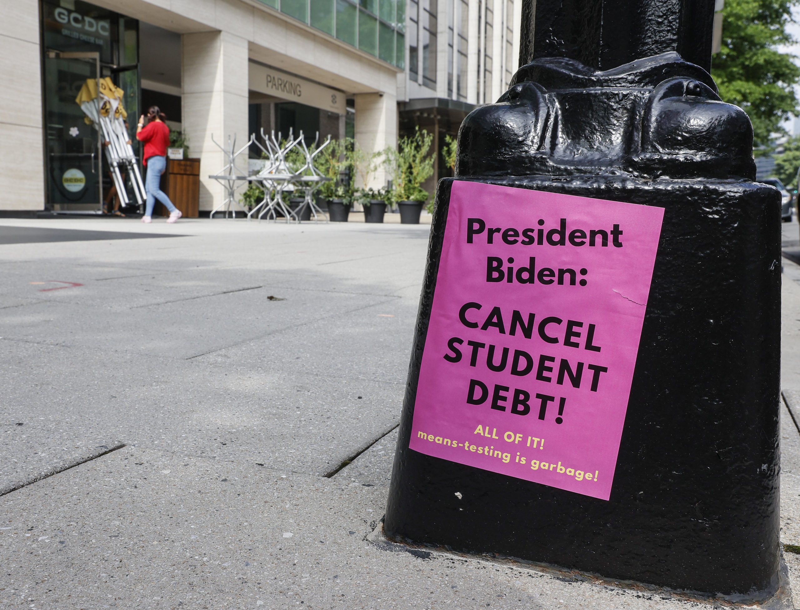 A sign asking President Biden to Cancel Student Debt is seen posted on Pennsylvania Ave near the white house staff entrance during a demonstration demanding that President Biden cancel student loan debt in August on July 27, 2022 at the Executive Offices in Washington, DC. (Photo by Jemal Countess/Getty Images for We, The 45 Million)