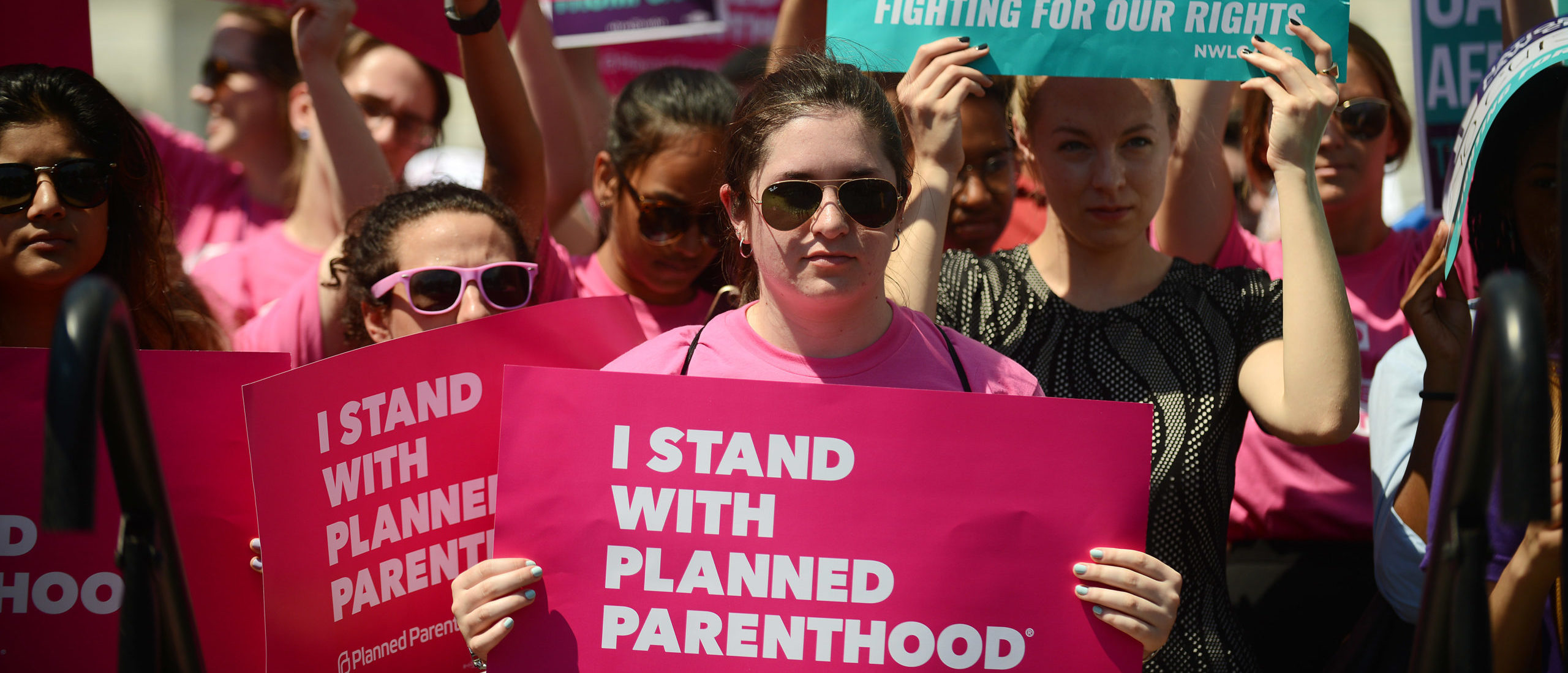 WASHINGTON, DC - JUNE 21: Protesters hold posters in support of Planned Parenthood at a rally to oppose the repeal of the Affordable Care Act and its replacement on Capitol Hill on June 21, 2017 in Washington, DC. Criticism is mounting on the GOP for health care reform legislation being done behind closed doors. (Photo by Astrid Riecken/Getty Images)