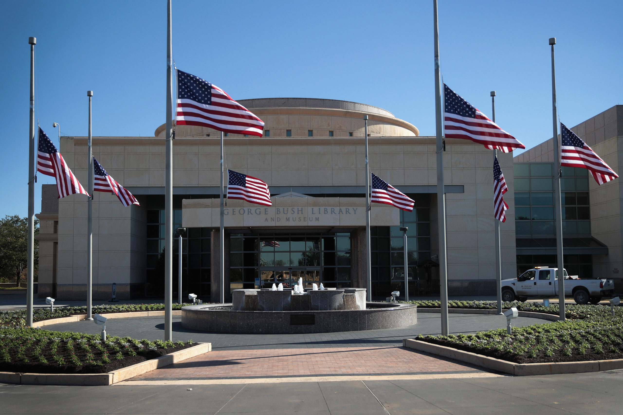 Flags fly at half-mast in front of the George H.W. Bush Presidential Library Center on the campus of Texas A&M University on December 2, 2018 in College Station, Texas. Bush, who died on November 30, will be buried next to his wife Barbara near the library on Thursday. (Photo by Scott Olson/Getty Images)