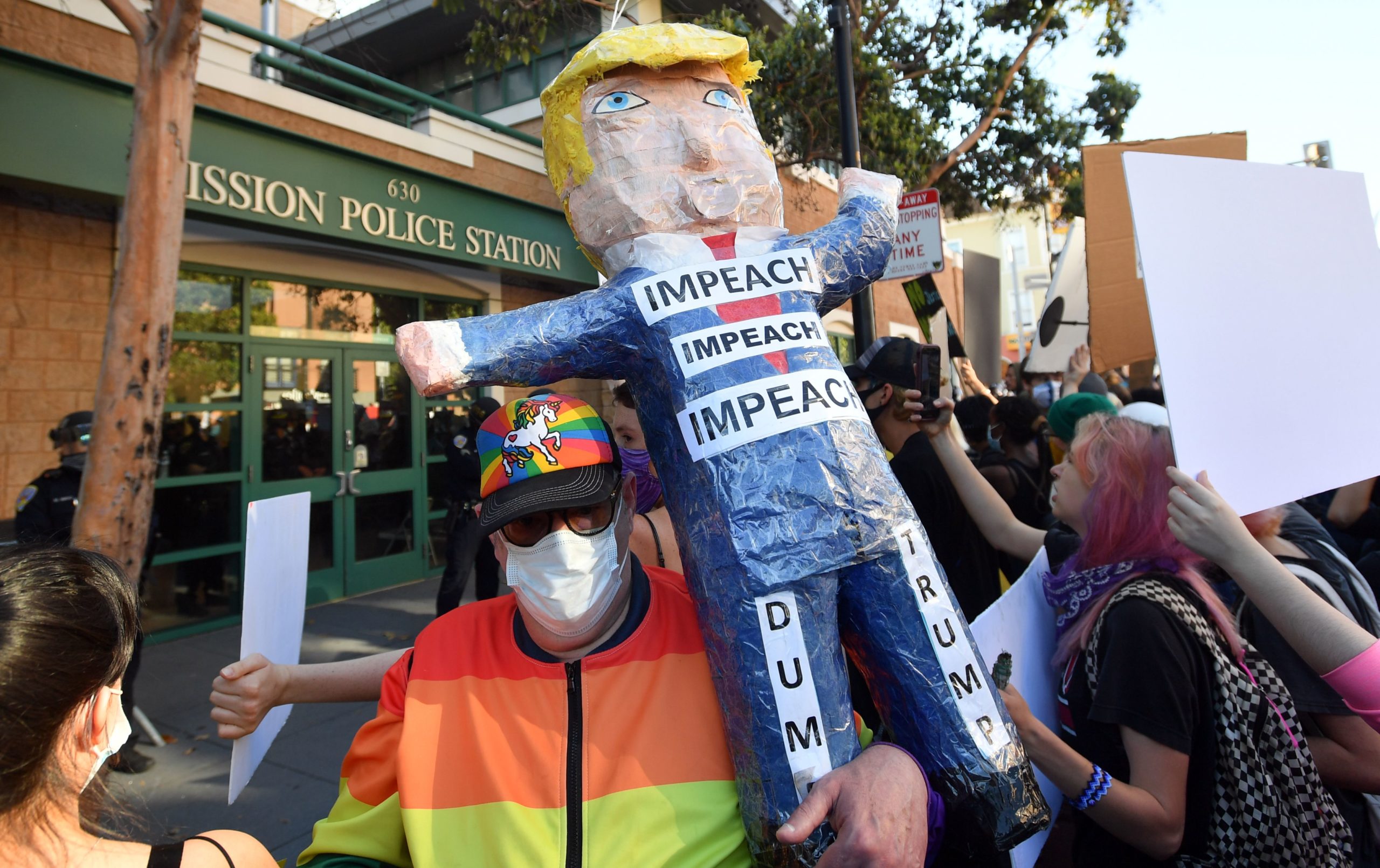 A protester holds a Donald Trump pinata as a crowd gathers in front of a San Francisco police station in San Francisco, California on June 3, 2020. - Thousands of people gathered at Dolores Park and marched through the city in support of George Floyd and against police brutality. (Photo by Josh Edelson / AFP) (Photo by JOSH EDELSON/AFP via Getty Images)