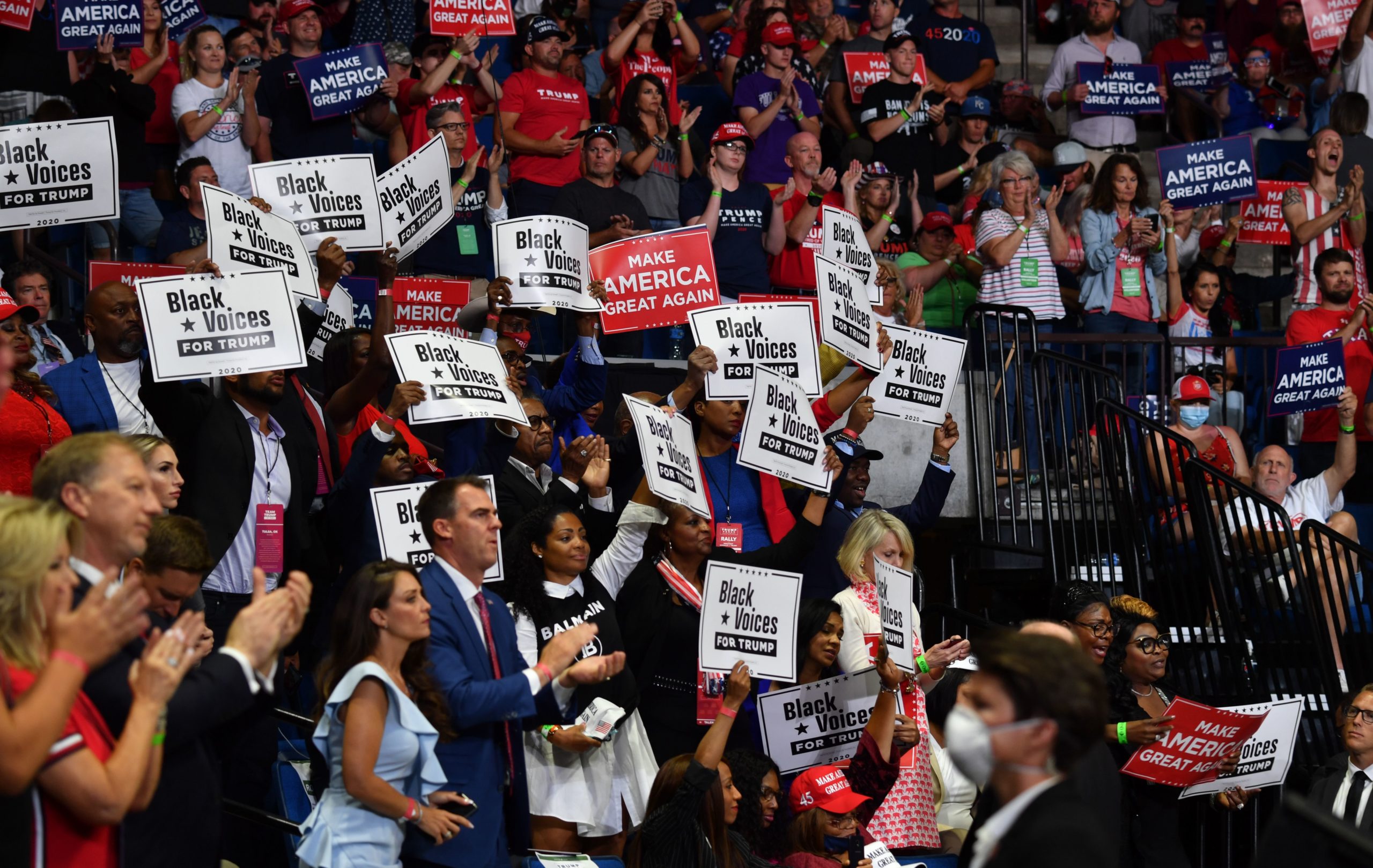 Governor Kevin Stitt claps among "Black Voices for Trump" supporters as US President Donald Trump speaks during a campaign rally at the BOK Center on June 20, 2020 in Tulsa, Oklahoma. - Hundreds of supporters lined up early for Donald Trump's first political rally in months, saying the risk of contracting COVID-19 in a big, packed arena would not keep them from hearing the president's campaign message. (Photo by Nicholas Kamm / AFP) (Photo by NICHOLAS KAMM/AFP via Getty Images)
