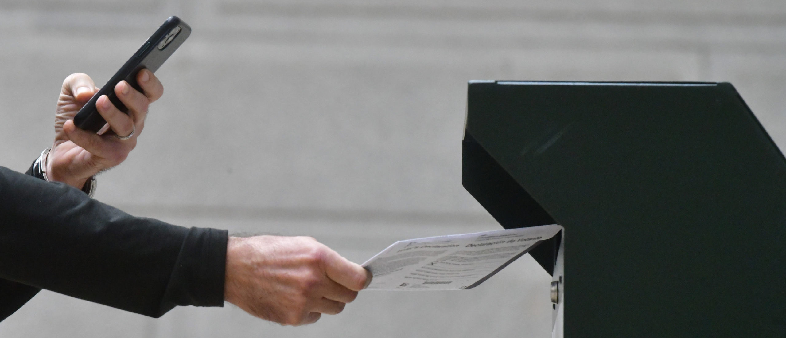 PHILADELPHIA, PA - OCTOBER 27: A man photographs himself depositing his ballot in an official ballot drop box while a long line of voters queue outside of Philadelphia City Hall at the satellite polling station on October 27, 2020 in Philadelphia, Pennsylvania. With the election only a week away, this new form of in-person voting by using mail ballots has enabled tens of millions of voters to cast their ballots before the general election. Vying to recapture the Keystone State's vital 20 electoral votes in order to bolster his reelection prospects, President Donald Trump held three rallies throughout Pennsylvania yesterday. (Photo by Mark Makela/Getty Images)