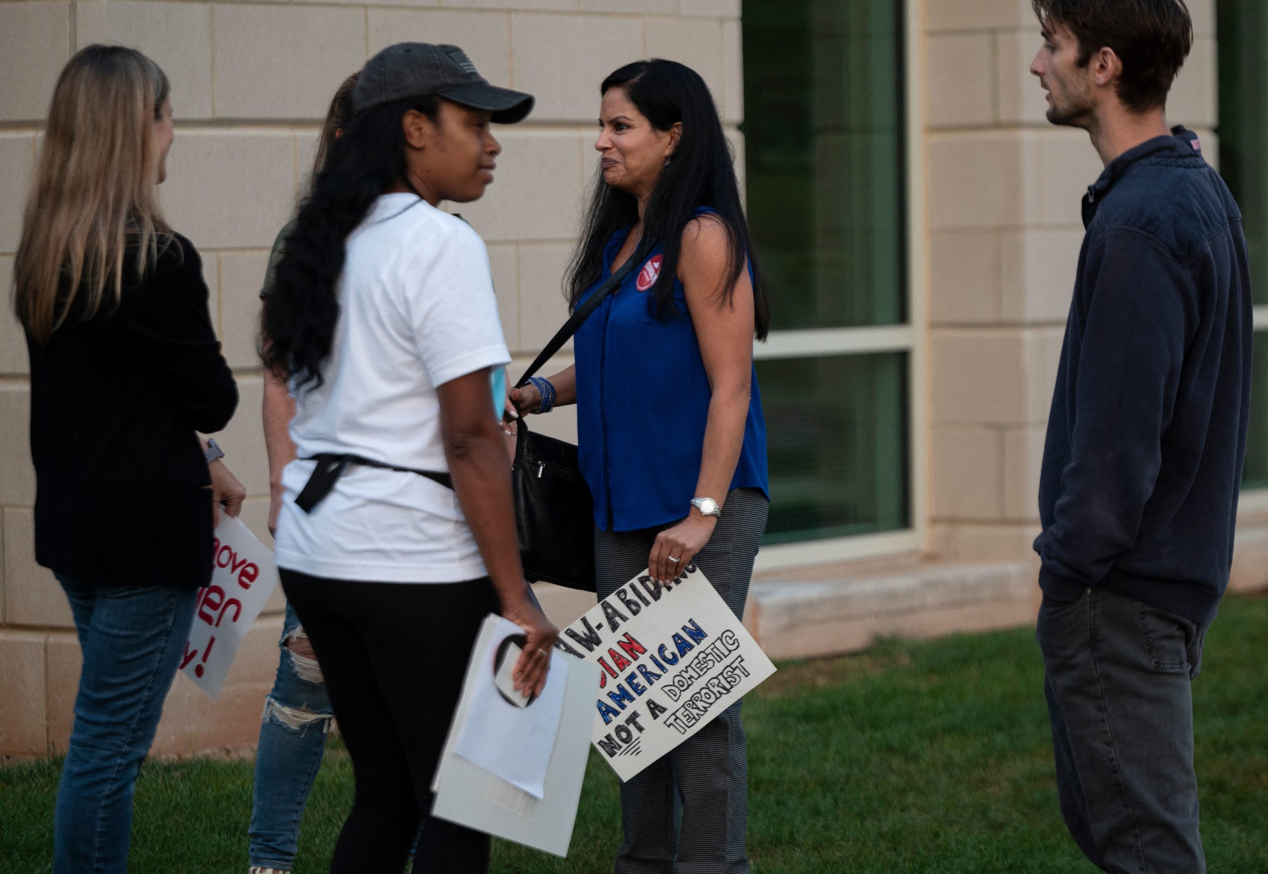 Protesters and activists stand outside a Loudoun County Public Schools (LCPS) board meeting in Ashburn, Virginia on October 12, 2021. (Photo by Andrew CABALLERO-REYNOLDS / AFP) (Photo by ANDREW CABALLERO-REYNOLDS/AFP via Getty Images)