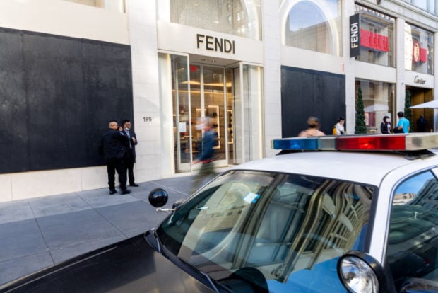 SAN FRANCISCO, CA - NOVEMBER 30: Pedestrians walk past a Fendi store with boarded up windows near Union Square on November 30, 2021 in San Francisco, California. Stores have increased security in response to a spike in thefts. (Photo by Ethan Swope/Getty Images)