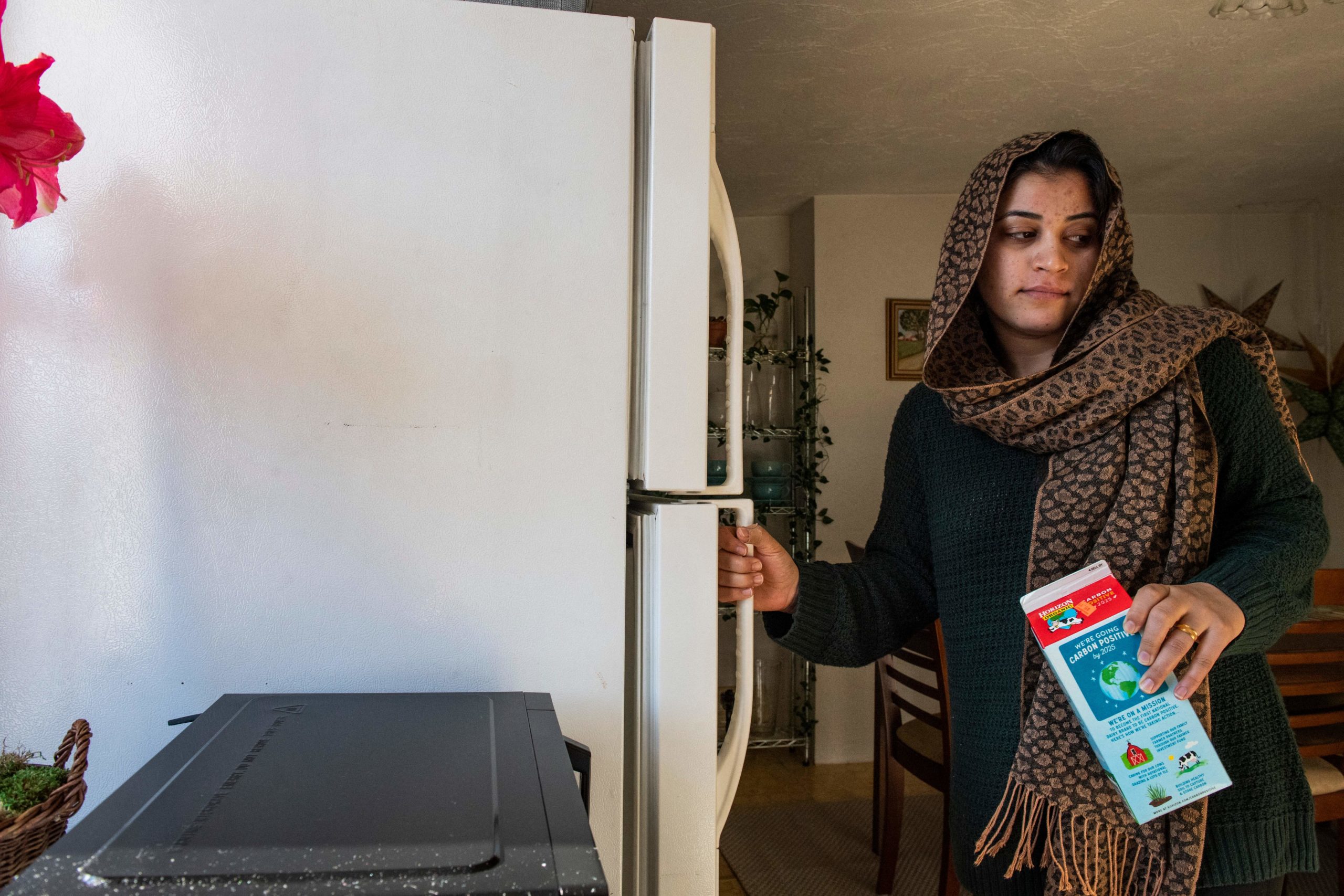 Afghani evacuee Sayeda, 23, prepares to make a morning smoothie, an American concept her and her husband Israr have been trying for a few weeks, in Charlestown, Massachusetts on February 21, 2022.