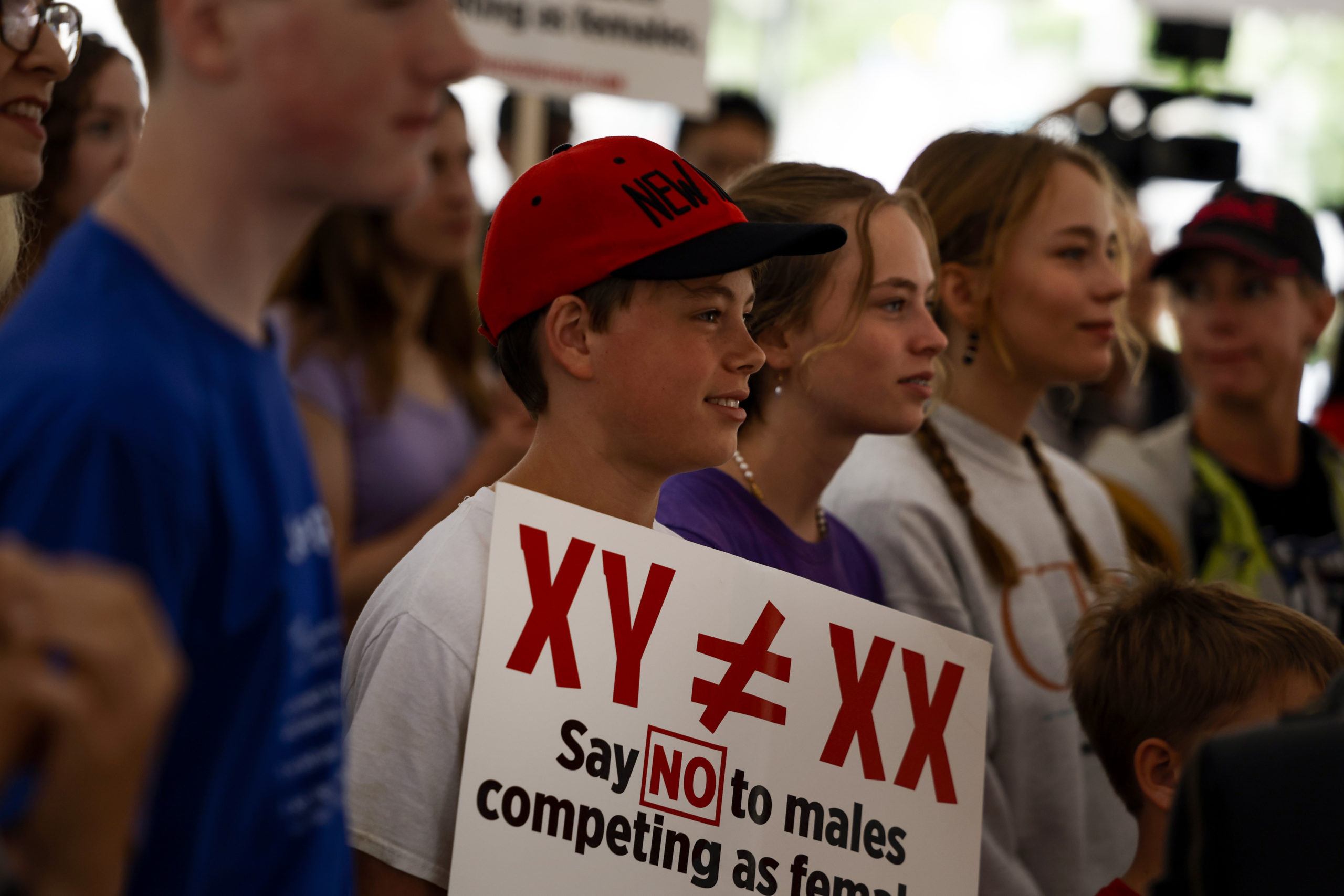 Demonstrators listen to the speaking program during an "Our Bodies, Our Sports" rally for the 50th anniversary of Title IX at Freedom Plaza on June 23, 2022 in Washington, DC. The rally, organized by multiple athletic women's groups was held to call on U.S. President Joe Biden to put restrictions on transgender females and "advocate to keep women's sports female."(Photo by Anna Moneymaker/Getty Images)