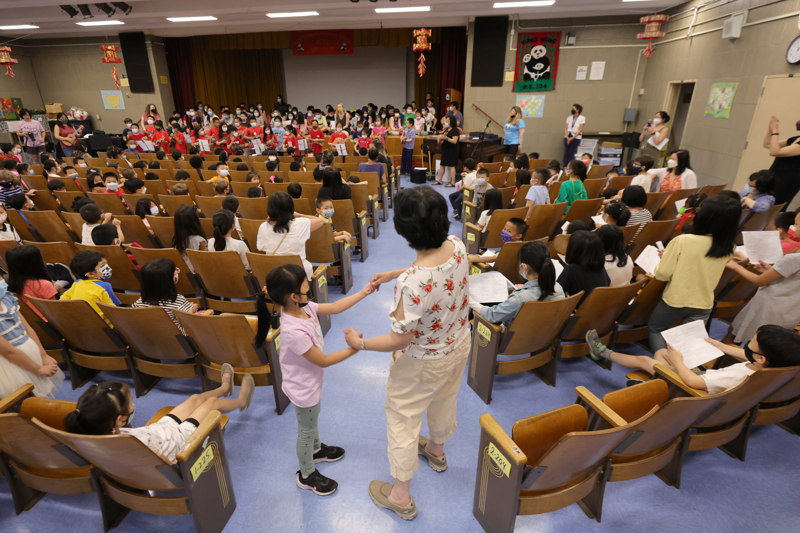 Principal Alice Hom dances with a student during a celebration on the last day of the school year, and her last day as principal of Yung Wing school P.S. 124 on June 27, 2022 in New York City. Hom served for more than 39 years in education, including 19 years as principal at P.S. 124. (Photo by Michael Loccisano/Getty Images)