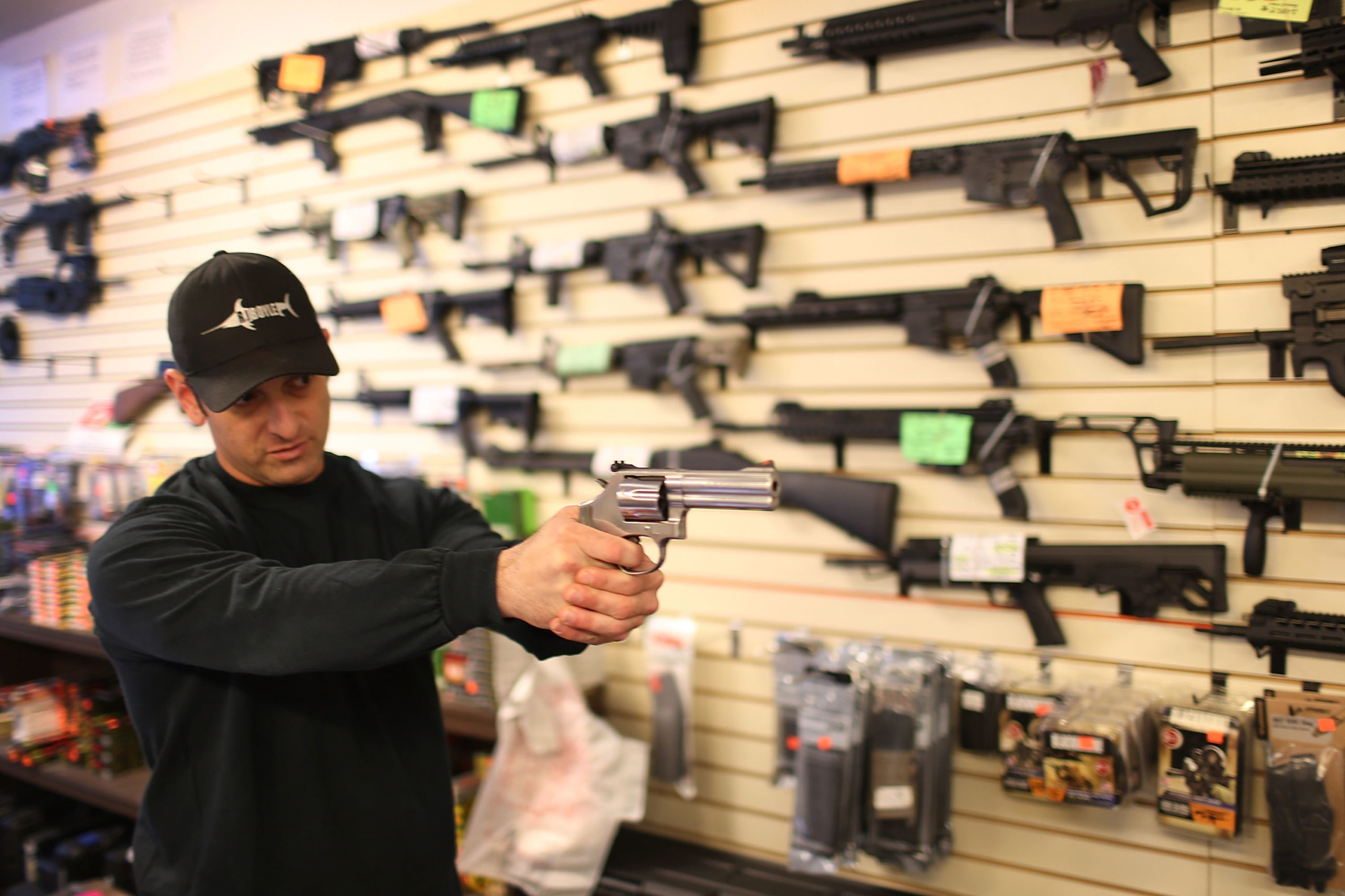 DELRAY BEACH, FL - JANUARY 05: Brandon Wexler shows a customer one of the weapons that she was picking up at the end of the three day waiting period at the K&W Gunworks store on the day that U.S. President Barack Obama in Washington, DC announced his executive action on guns on January 5, 2016 in Delray Beach, Florida. President Obama announced several measures that he says are intended to advance his gun safety agenda. (Photo by Joe Raedle/Getty Images)