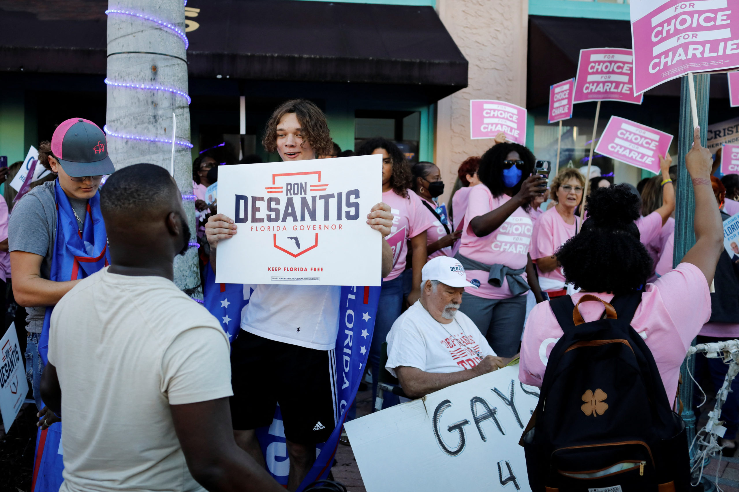 Supporters of Democratic challenger Charlie Crist and Florida Governor Ron DeSantis argue during a gathering outside the Sunrise Theatre before the candidates' debate ahead of midterm elections, in Fort Pierce, Florida, U.S., October 24, 2022. REUTERS/Marco Bello