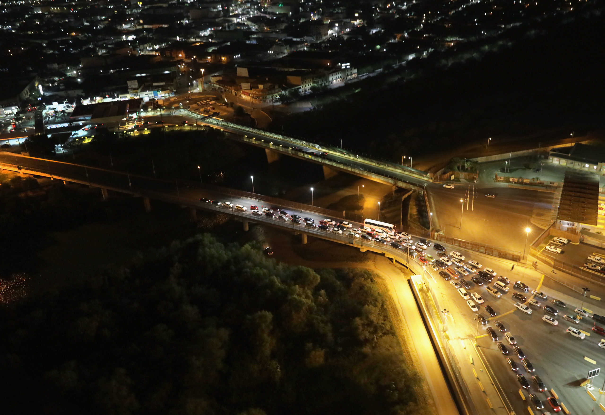 HIDALGO, TX - NOVEMBER 06: Vehicles wait in line to enter the United States after crossing the international bridge from Mexico (L), on November 6, 2018 in Hidalgo, Texas. The U.S. Army, as part of "Operation Faithful Patriot" set up razor wire at the Hidalgo port of entry last week, ahead of the possible arrival of the migrant caravan in upcoming weeks. The soldiers are expected to "harden" additional border crossings as part of their deployment to the southern border. (Photo by John Moore/Getty Images)