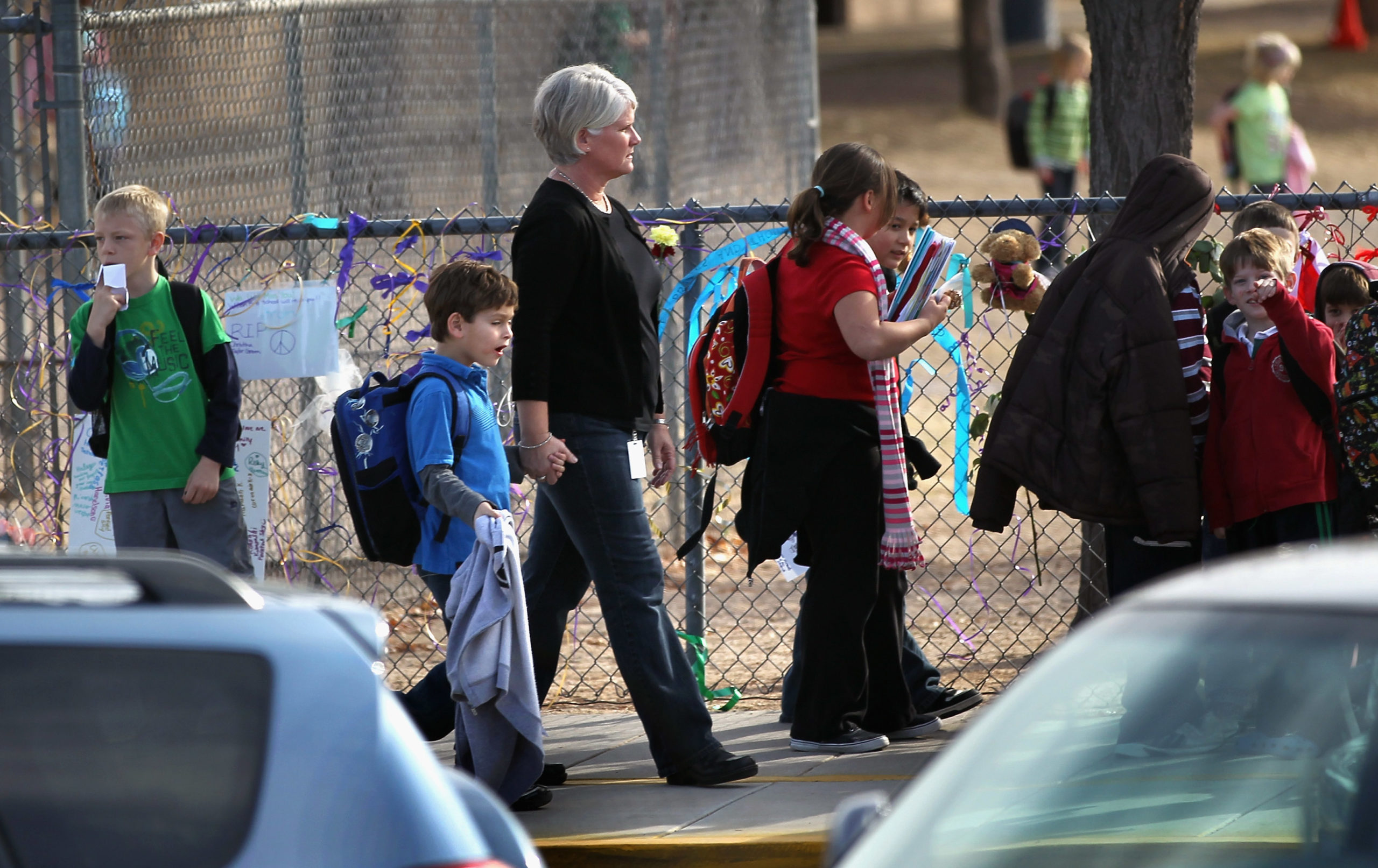 Students are picked up from the Mesa Verde Elementary School after their first day back following the slaying of schoolmate Christina Green, 9, on January 10, 2011 in Tuscon, Arizona. Christina was killed along with five others when a gunmen opened fire on U.S. Rep. Gabrielle Giffords (D-AZ), wounding her and more than a dozen others Friday. Giffords was holding a public event entitled Congress on your Corner outside a Safeway grocery store in Tuscon when a gunmen began a shooting rampage. (Photo by John Moore/Getty Images)