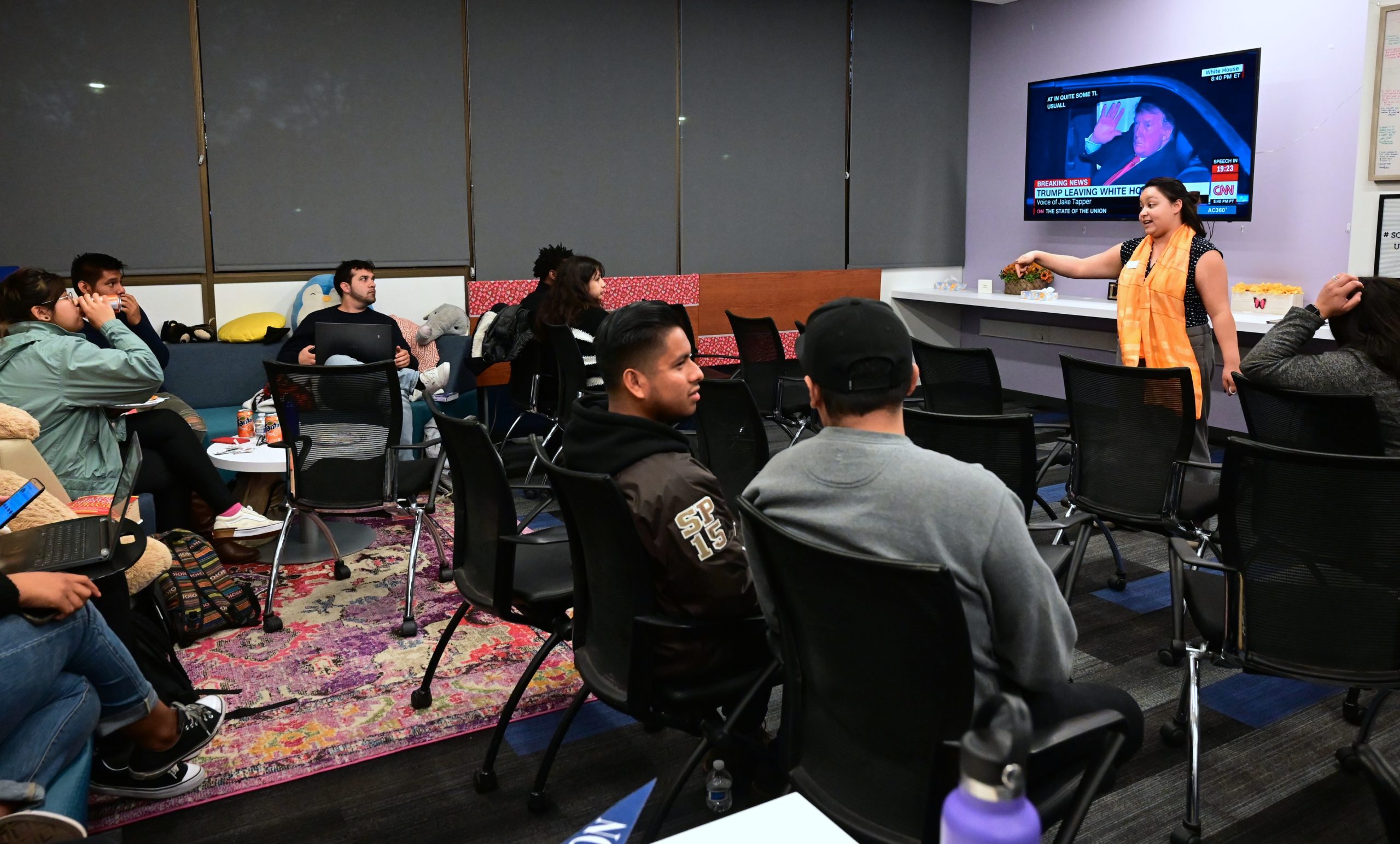 California State University Fullerton students gather for a State of the Union watch party at the Dreamers Research center on campus in Fullerton, California on February 5, 2019. - US President Donald Trump is seen waving on the screen on his way to speak at the State of the Union address. Dreamers Research Center coordinator Martha Perez, seen gesturing, attended the State of the Union address two years ago as a guest of Ventura County Representative Julia Brownley. (Photo by Frederic J. BROWN / AFP) (Photo credit should read FREDERIC J. BROWN/AFP via Getty Images)