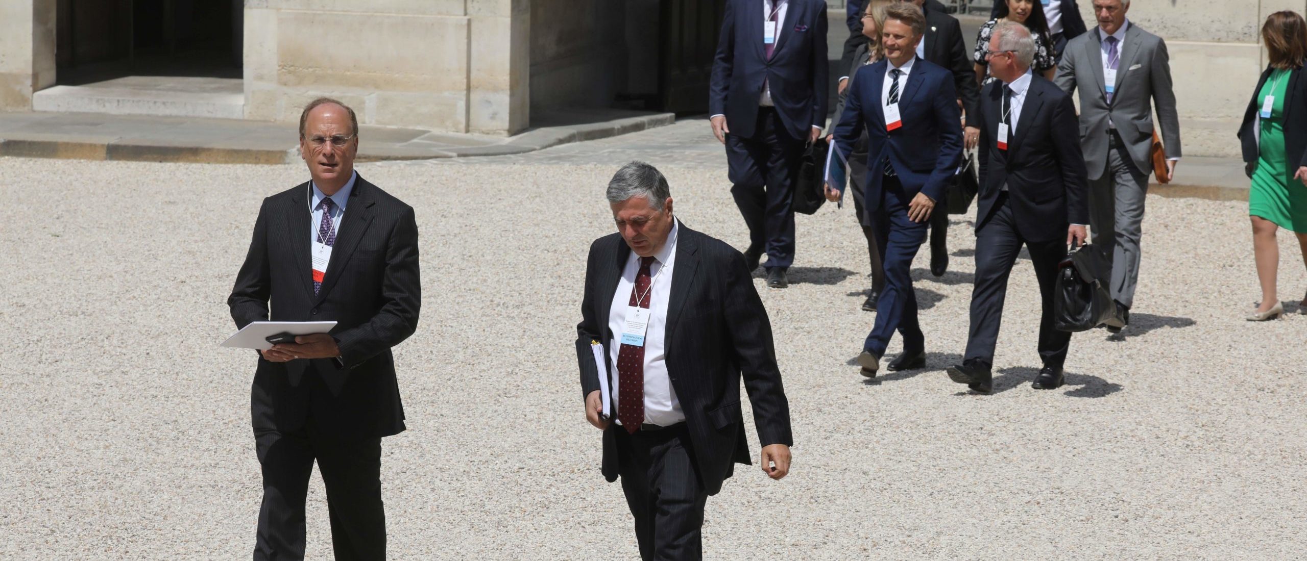 Chairman and CEO of BlackRock, Larry Fink (L) and CEO of Blackrock France, Jean-Francois Cirelli, attend a meeting about climate action investments with heads of sovereign wealth funds and French President Emmanuel Macron, at the Elysee Palace, in Paris on July 10, 2019. (Photo by Ludovic MARIN / AFP)