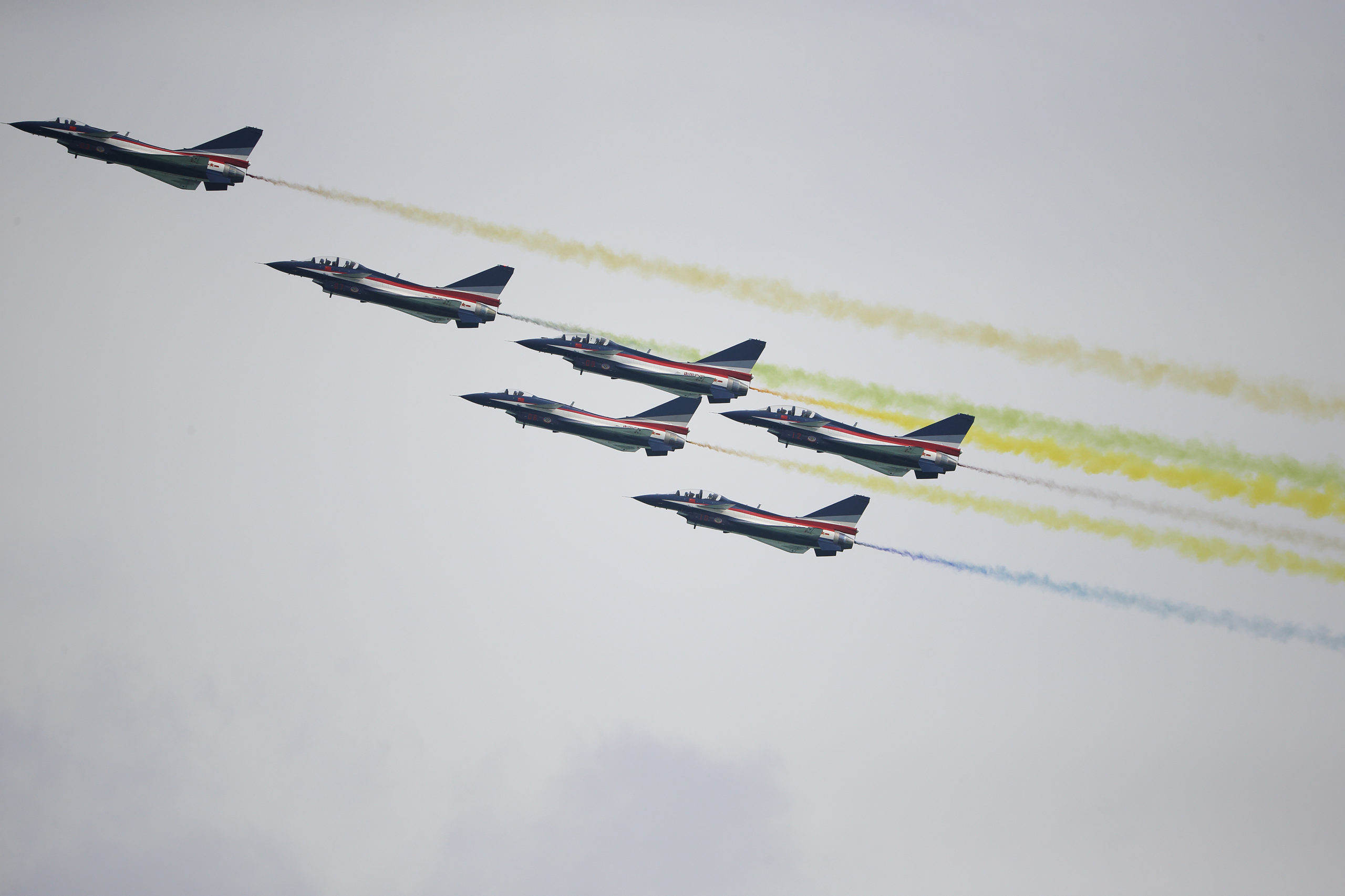 SINGAPORE - FEBRUARY 09: J-10 fighter jets of China's People's Liberation Army Air Force Ba Yi aerobatics team perform an aerial display during the Singapore Airshow media preview on February 9, 2020 in Singapore.