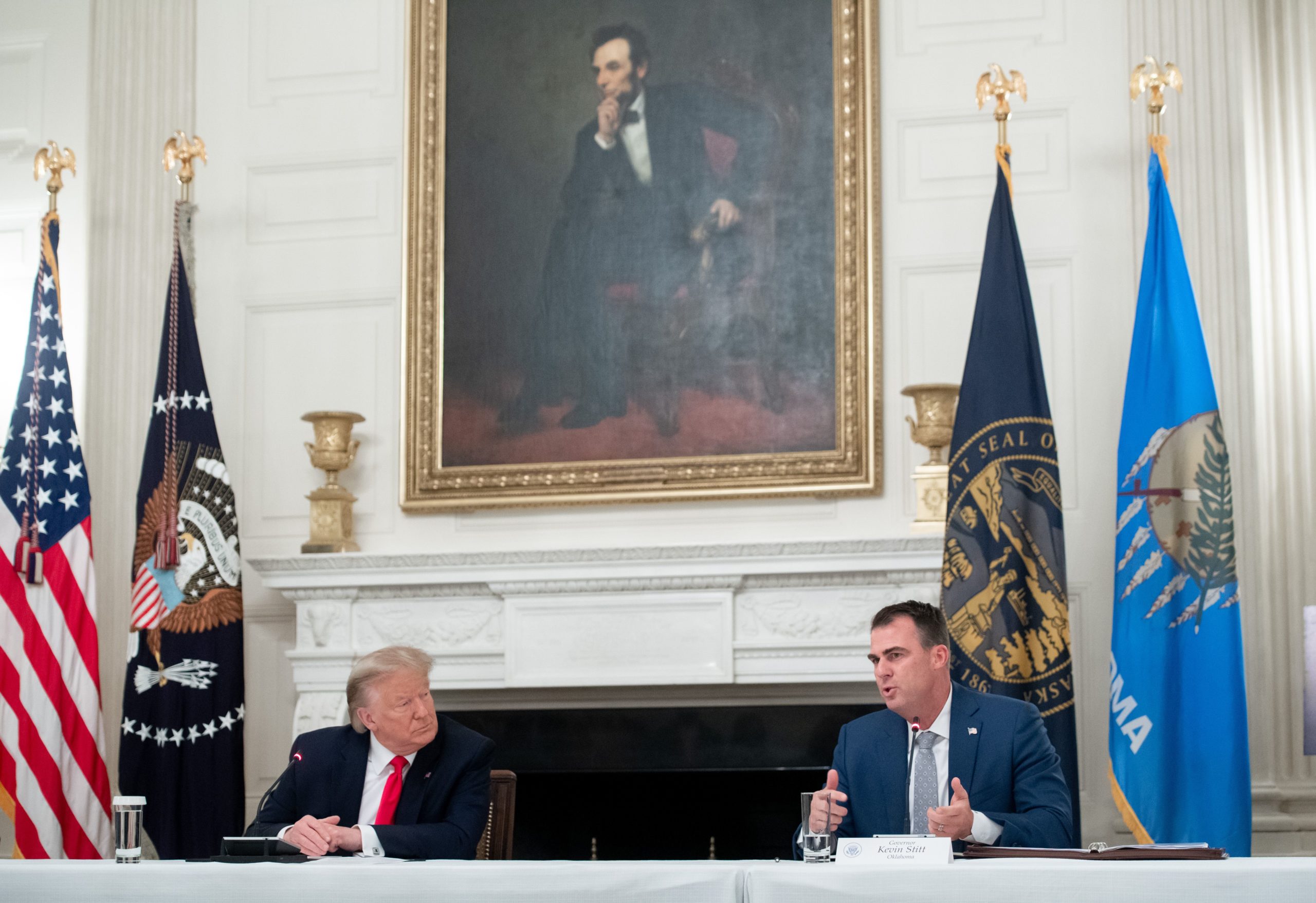 Oklahoma Governor Kevin Stitt speaks alongside US President Donald Trump (L) as he holds a roundtable discussion with Governors about economic reopening of closures due to COVID-19, known as coronavirus, in the State Dining Room of the White House in Washington, DC, June 18, 2020. (Photo by SAUL LOEB / AFP) (Photo by SAUL LOEB/AFP via Getty Images)