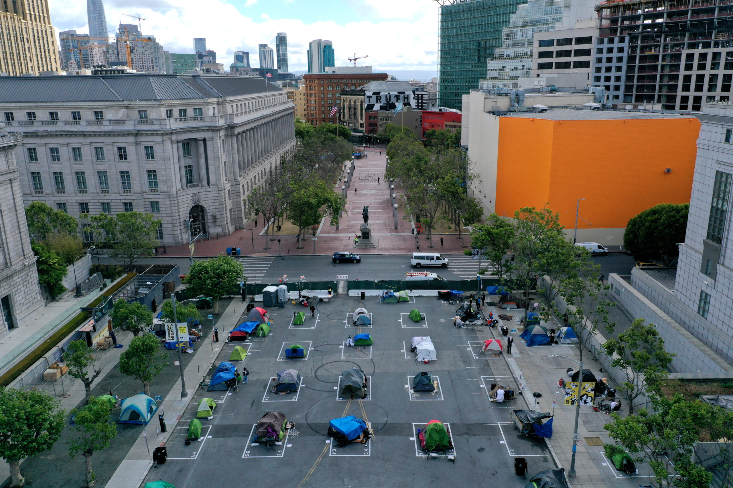 SAN FRANCISCO, CALIFORNIA - MAY 18: An aerial view of San Francisco's first temporary sanctioned tent encampment for the homeless on May 18, 2020 in San Francisco, California. After public outrage mounted over a surge of homeless people and tents filling the streets of San Francisco during the coronavirus (COVID-19) pandemic, the City opened its first temporary sanctioned tent encampment this week. The camp provides a safe sleeping area in a fenced-off space near City Hall with marked spots for tents that practice social distancing. Toilets, hand washing stations and 24 hours security will also be provided. Other locations throughout the city will be opening soon. (Photo by Justin Sullivan/Getty Images)