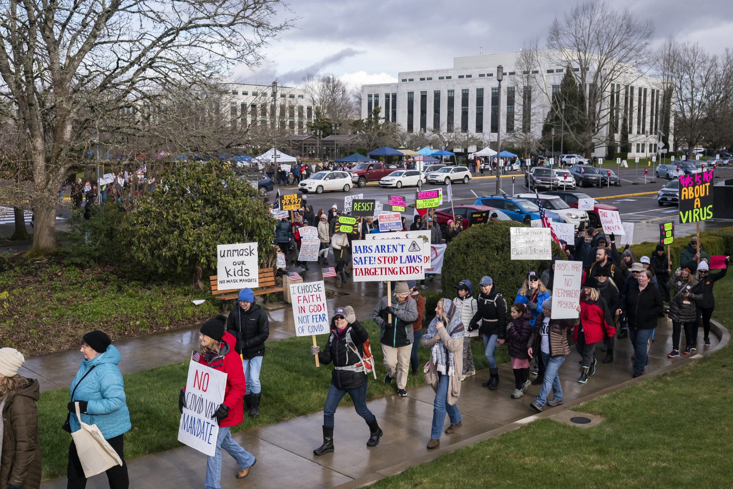 Attendees march during a rally against vaccine and mask mandates at the state capitol on February 1, 2022 in Salem, Oregon. After listening to speakers outside the building, the crowd was successful in getting state troopers to let some maskless members into the statehouse. (Photo by Nathan Howard/Getty Images)
