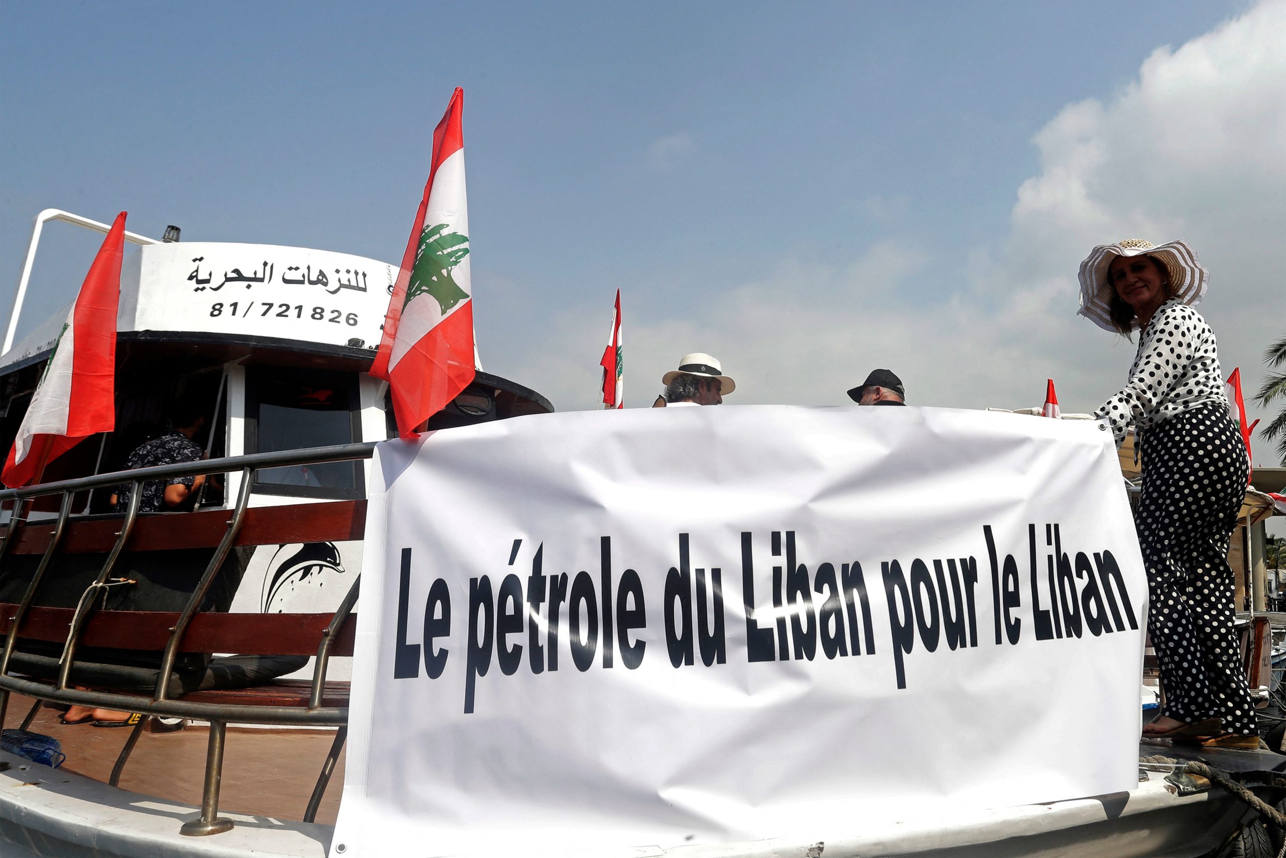 Lebanese protesters take part in a rally by sailing in boats with slogans in French affirming Lebanon's right to its offshore gas wealth, from the southern coastal city of Tyre towards Naqoura near the maritime border with Israel on September 4, 2022. - The maritime border dispute between Lebanon and Israel escalated in early June, after Israel moved a production vessel to the Karish offshore field, which is partly claimed by Lebanon. The move prompted Beirut to call for the resumption of US-mediated negotiations on the demarcation dispute.