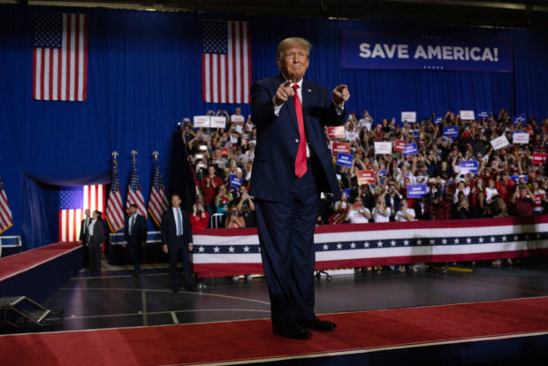 WARREN, MI - OCTOBER 01: Former U.S. President Donald Trump waves to the crowd during a Save America rally on October 1, 2022 in Warren, Michigan. Trump has endorsed Republican gubernatorial candidate Tudor Dixon, Secretary of State candidate Kristina Karamo, Attorney General candidate Matthew DePerno, and Republican businessman John James ahead of the November midterm election. (Photo by Emily Elconin/Getty Images)
