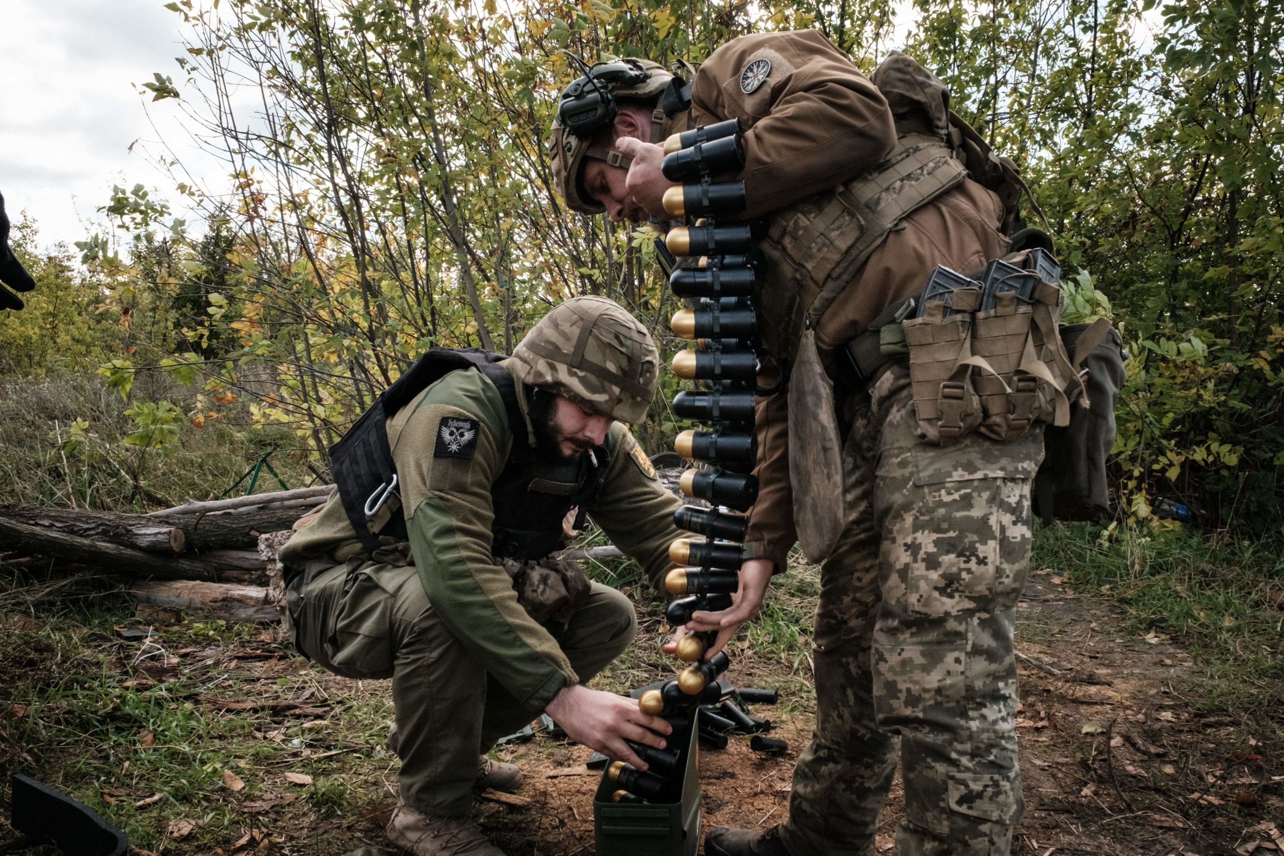 Soldiers of Ukraine's 5th Regiment of Assault Infantry put ammunition into a crate before setting a US-made MK-19 automatic grenade launcher towards Russian positions in less than 800 metres away at a front line near Toretsk in the Donetsk region on October 12, 2022, amid the Russian invasion of Ukraine. 